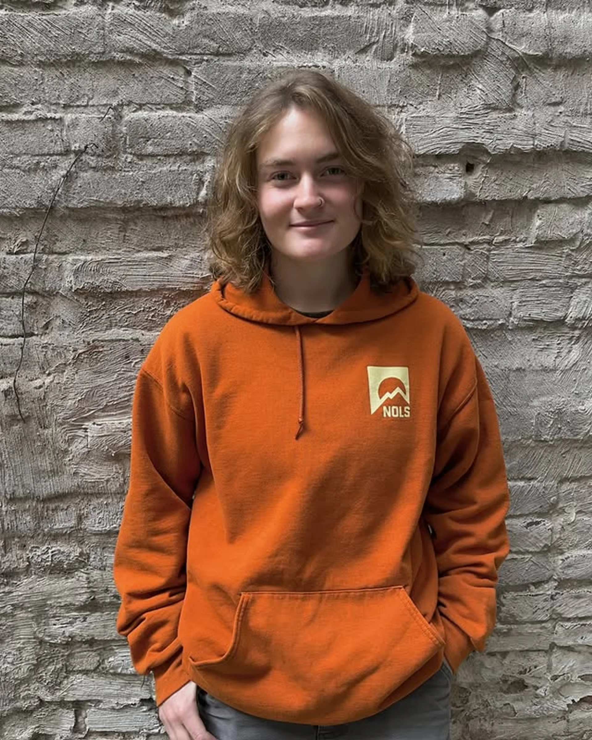 A woman with a medium-length dark brown Cowgirl Cut hairstyle, featuring soft shaggy layers and curtain bangs, exemplifying a top 2025 NYC hair trend. - Preview 3