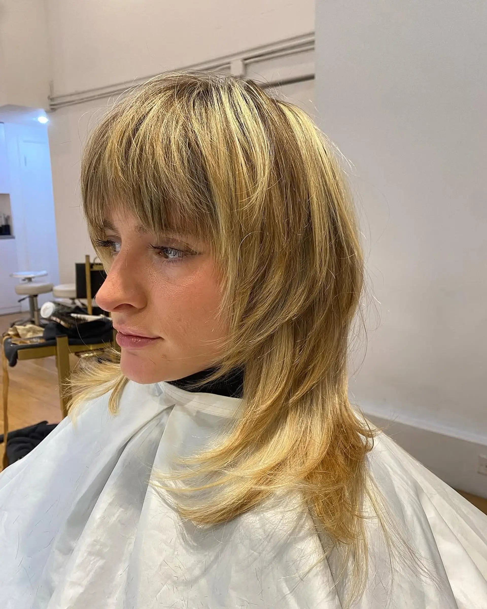 A medium length shag with textured layers and face-framing curtain bangs. 1