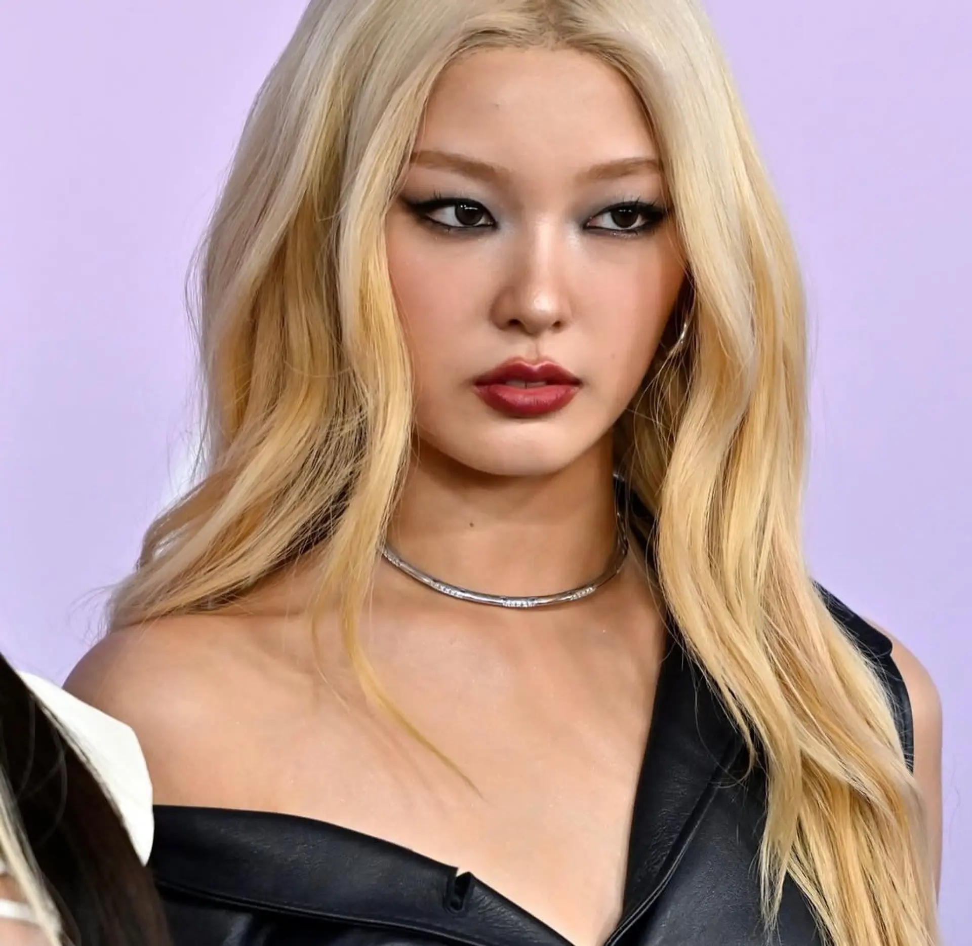 Long platinum blonde hair styled with a center part and soft, face-framing waves. 1
