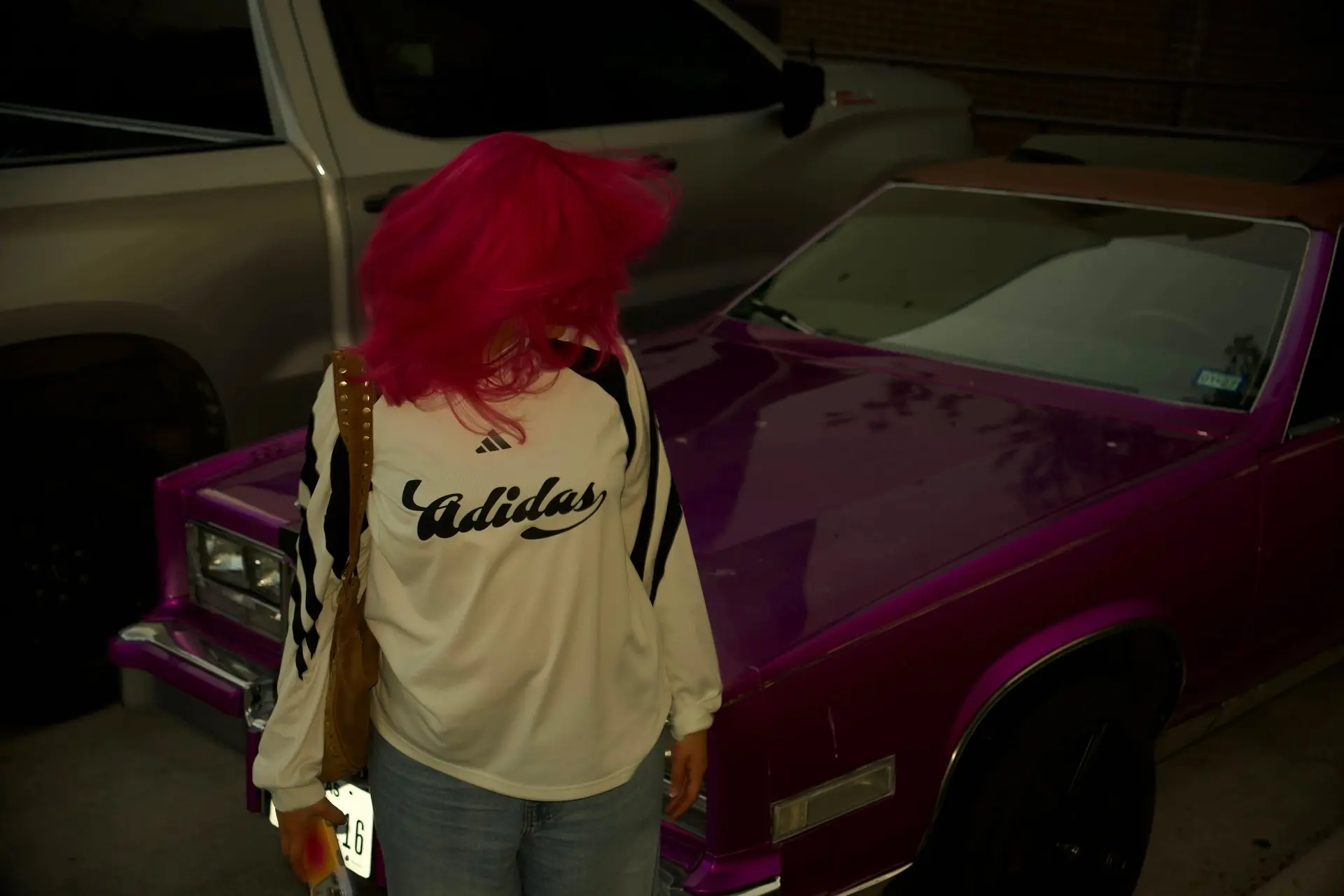 A shoulder-length vivid hot pink hair style captured in dynamic motion. 1