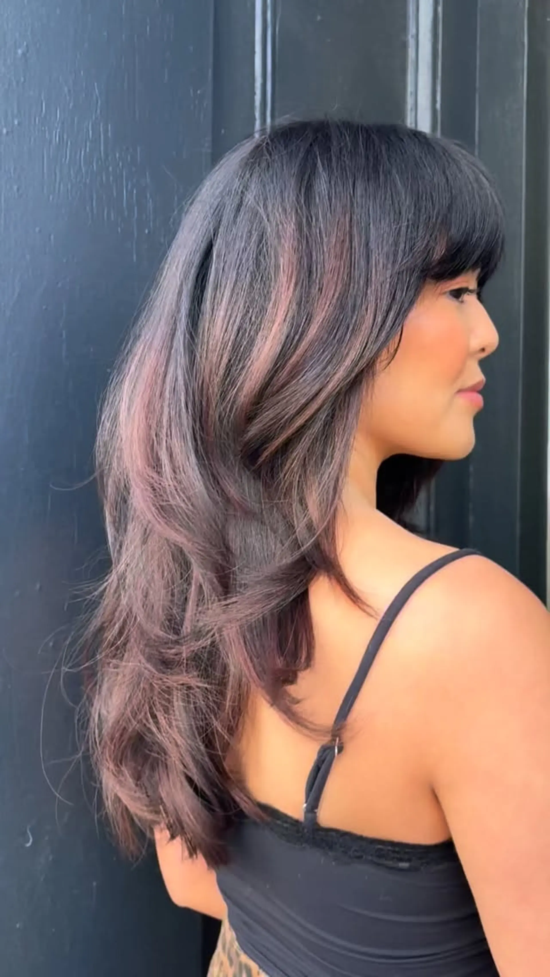 Long cascading layers with a full curved fringe and soft dusty-rose dimensional tones. 1