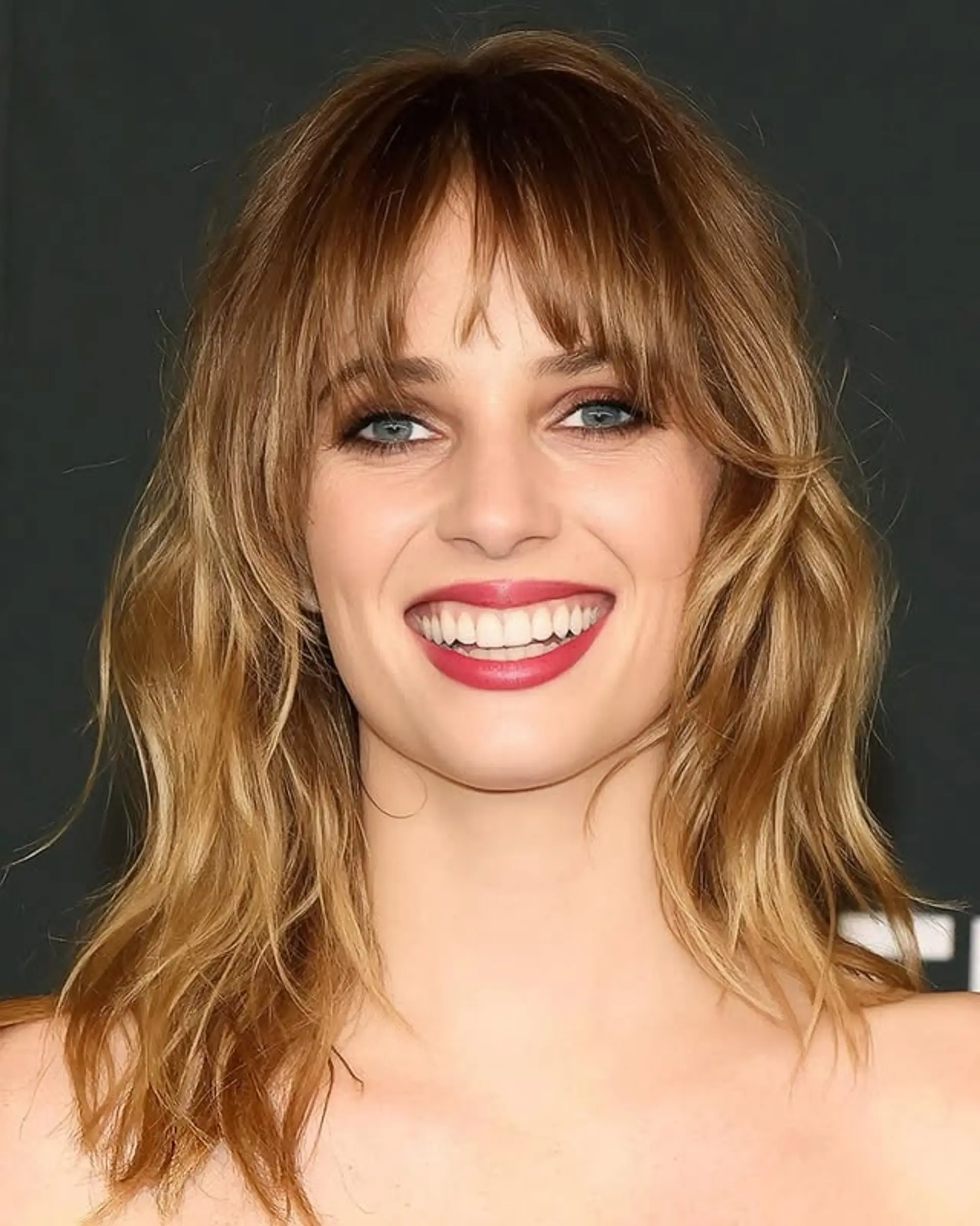 This wavy shag haircut features layered waves and trendy curtain bangs. 1