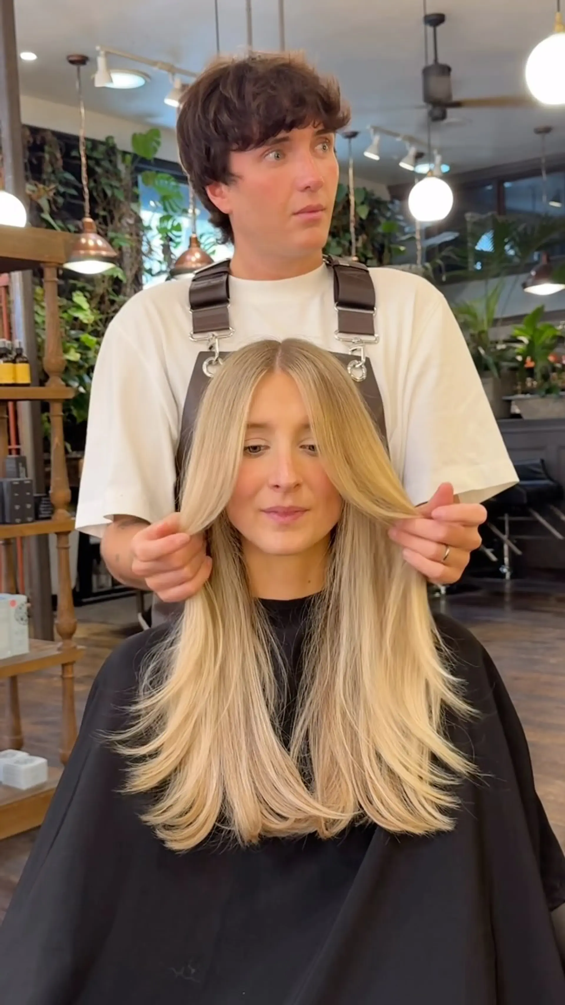 Long creamy blonde hair cut with face-framing curtain layers and smooth, gently rounded ends. 1