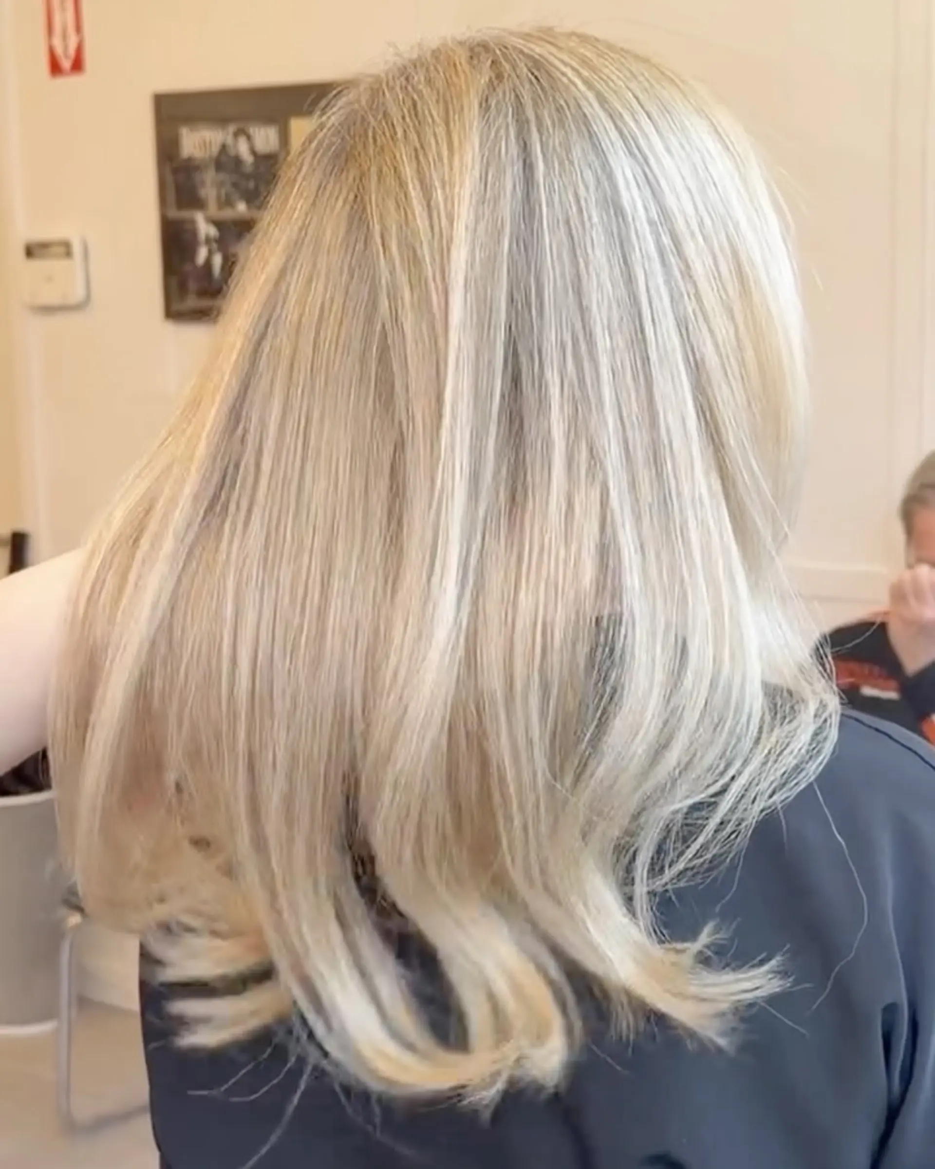 Long, smooth blonde hair styled straight with gentle movement towards the ends. 1