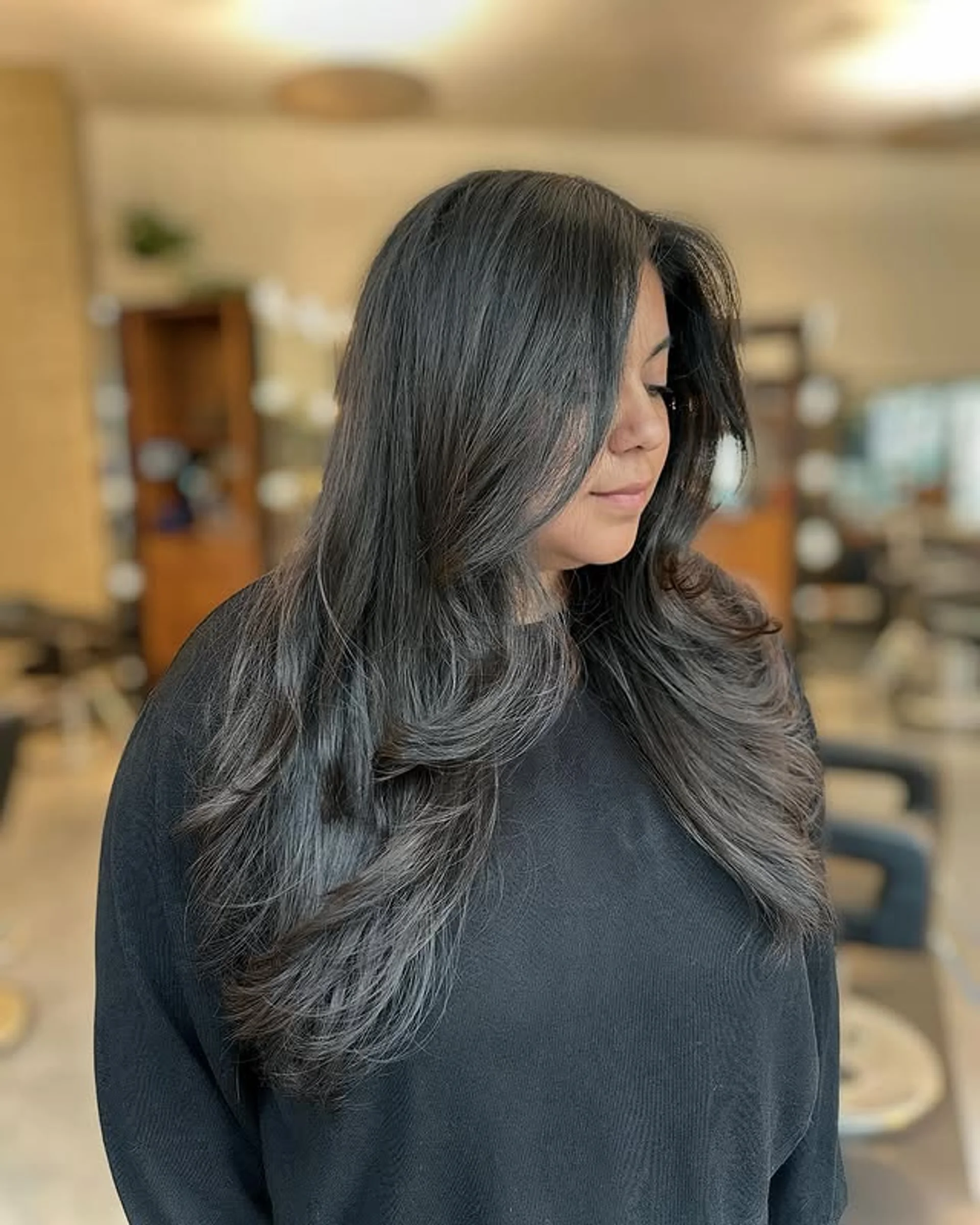 Softly blended gray coverage on long wavy hair with subtle highlights - Preview 2