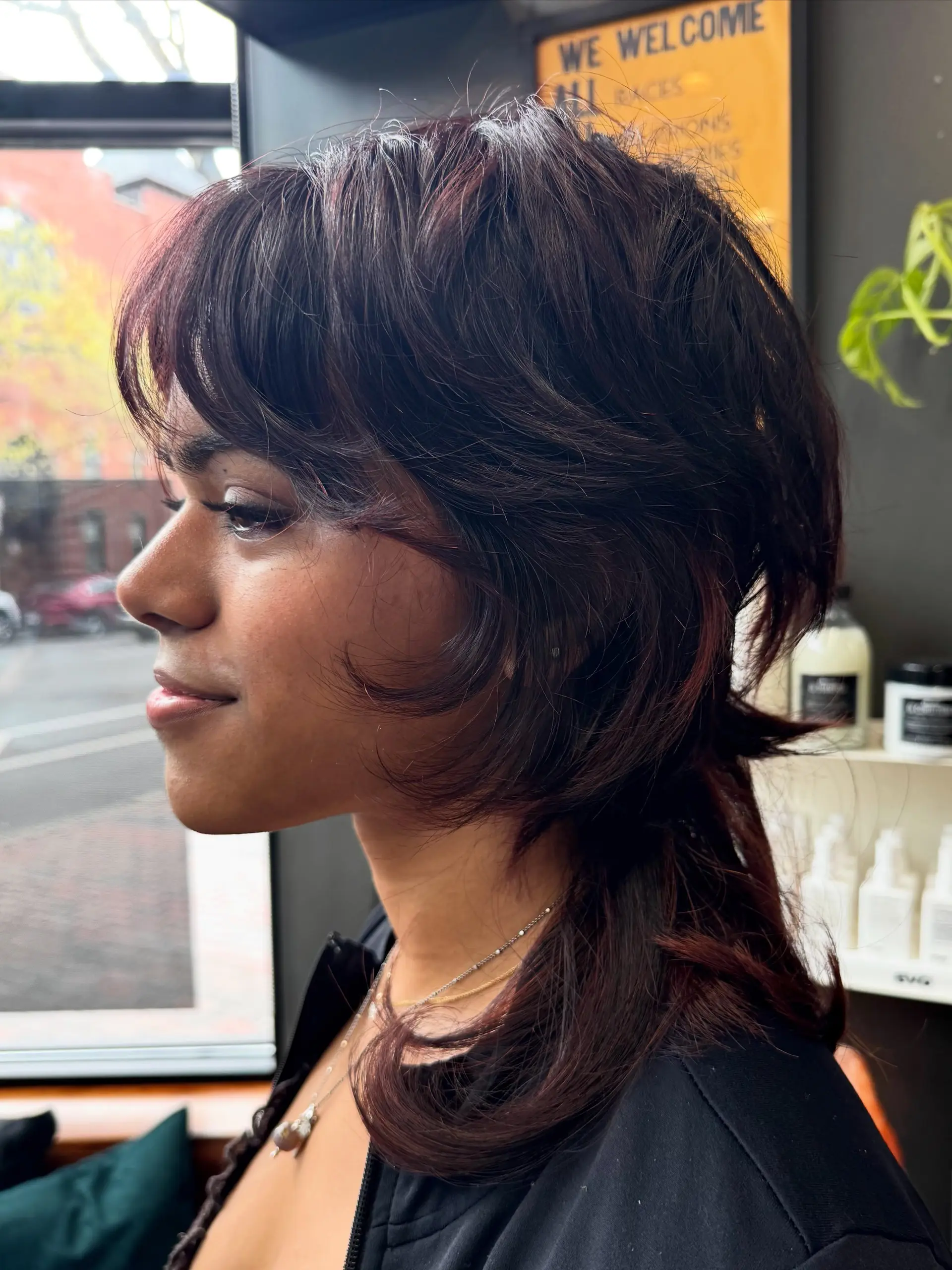 A textured jellyfish shag haircut featuring short, rounded face-framing layers and curtain bangs paired with longer, flicked ends at the base. 1