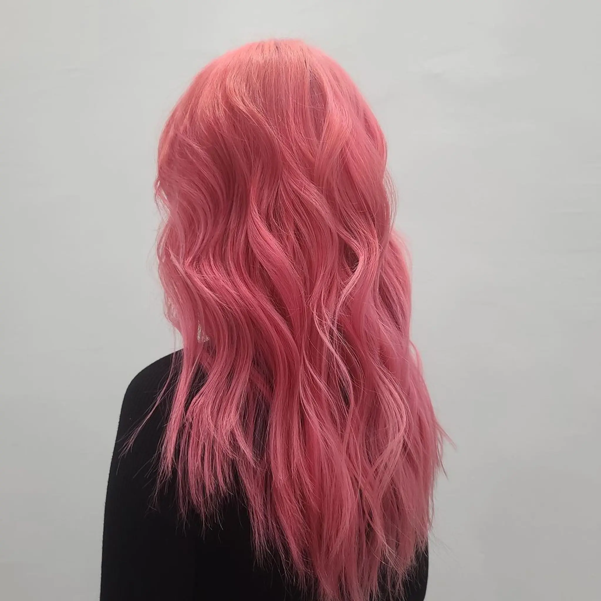 Long, wavy pink hair with a vibrant and playful look.