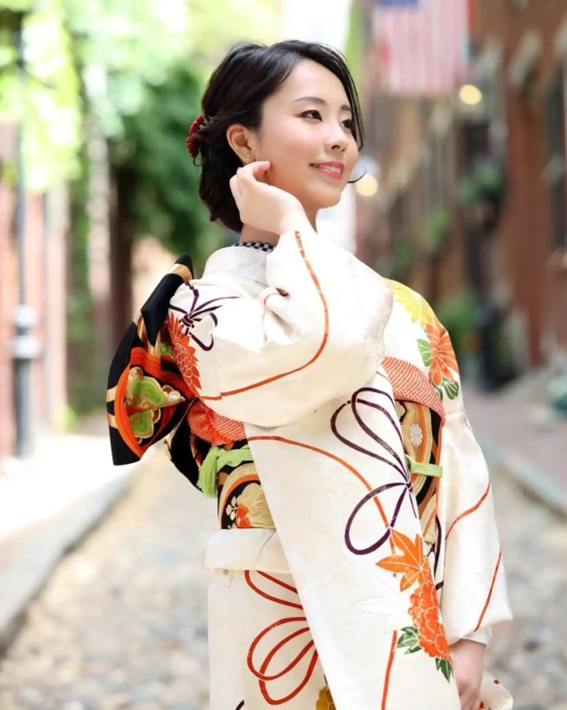 An elegant low updo crafted with soft, swept-back styling and paired with a subtle hair accessory to complement traditional kimono attire. 1