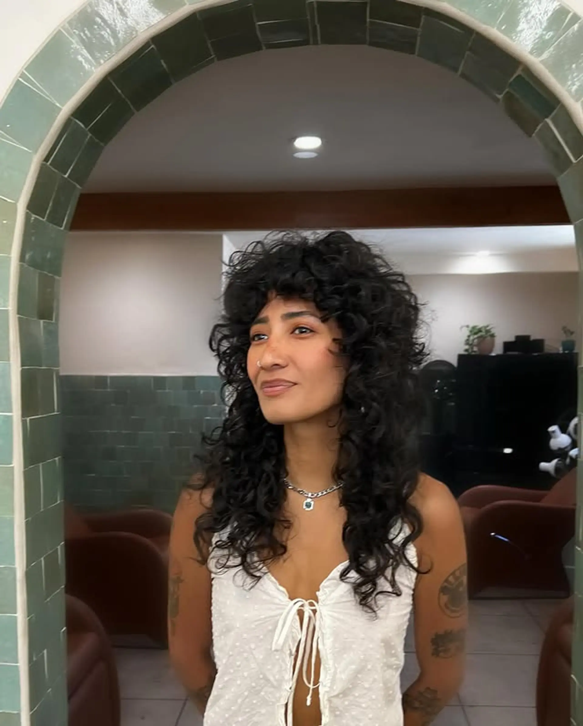 A modern shag with textured layers and curly bangs. 1