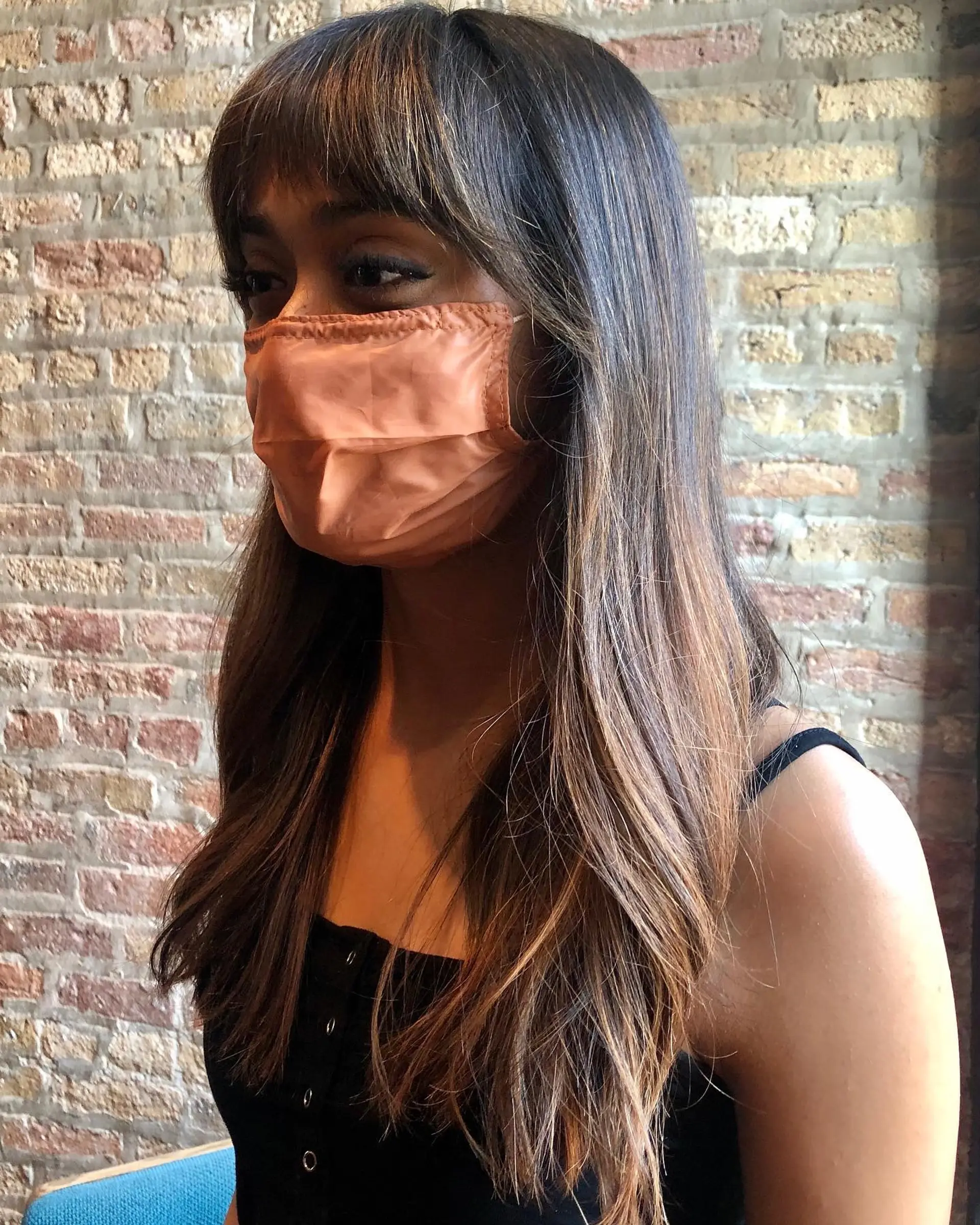 Long, straight layers with curtain bangs and balayage highlights. 1