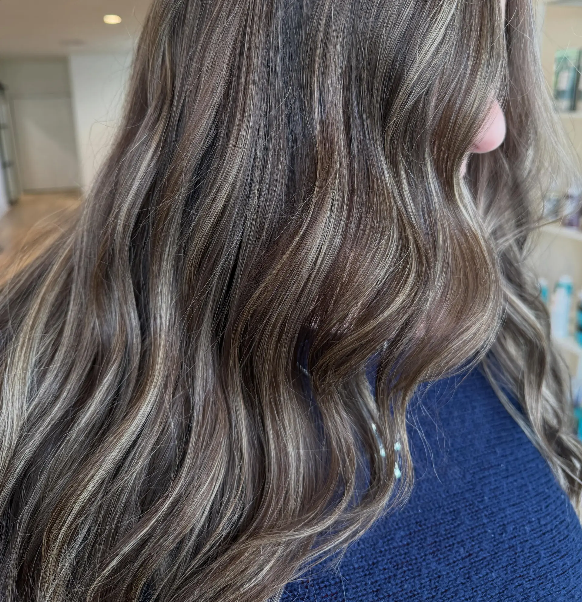 Long wavy brunette hair featuring fine ash blonde dimensional highlights. 1