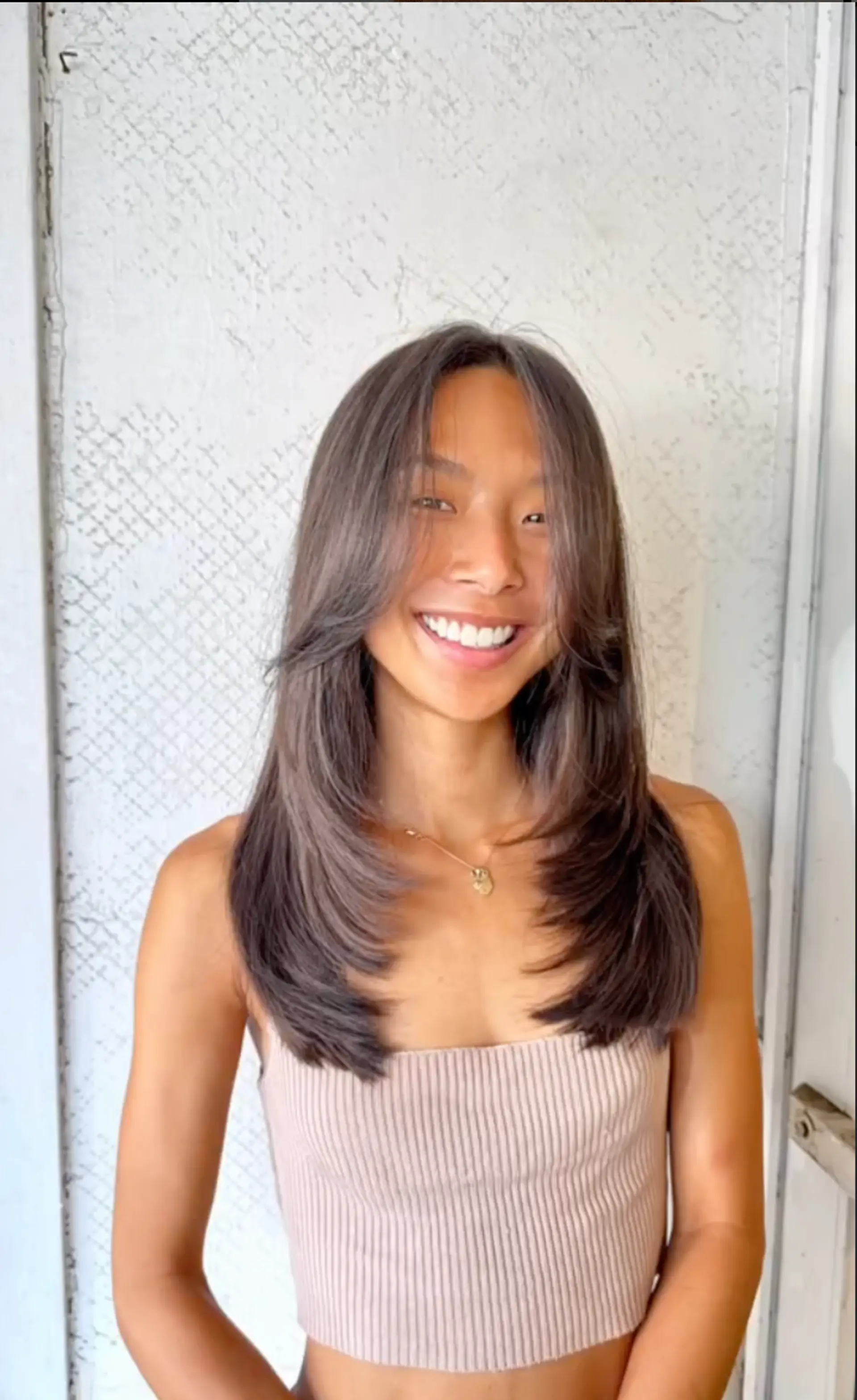 Long, sleek layers with feathered ends and a center part that adds symmetry and shine. 1