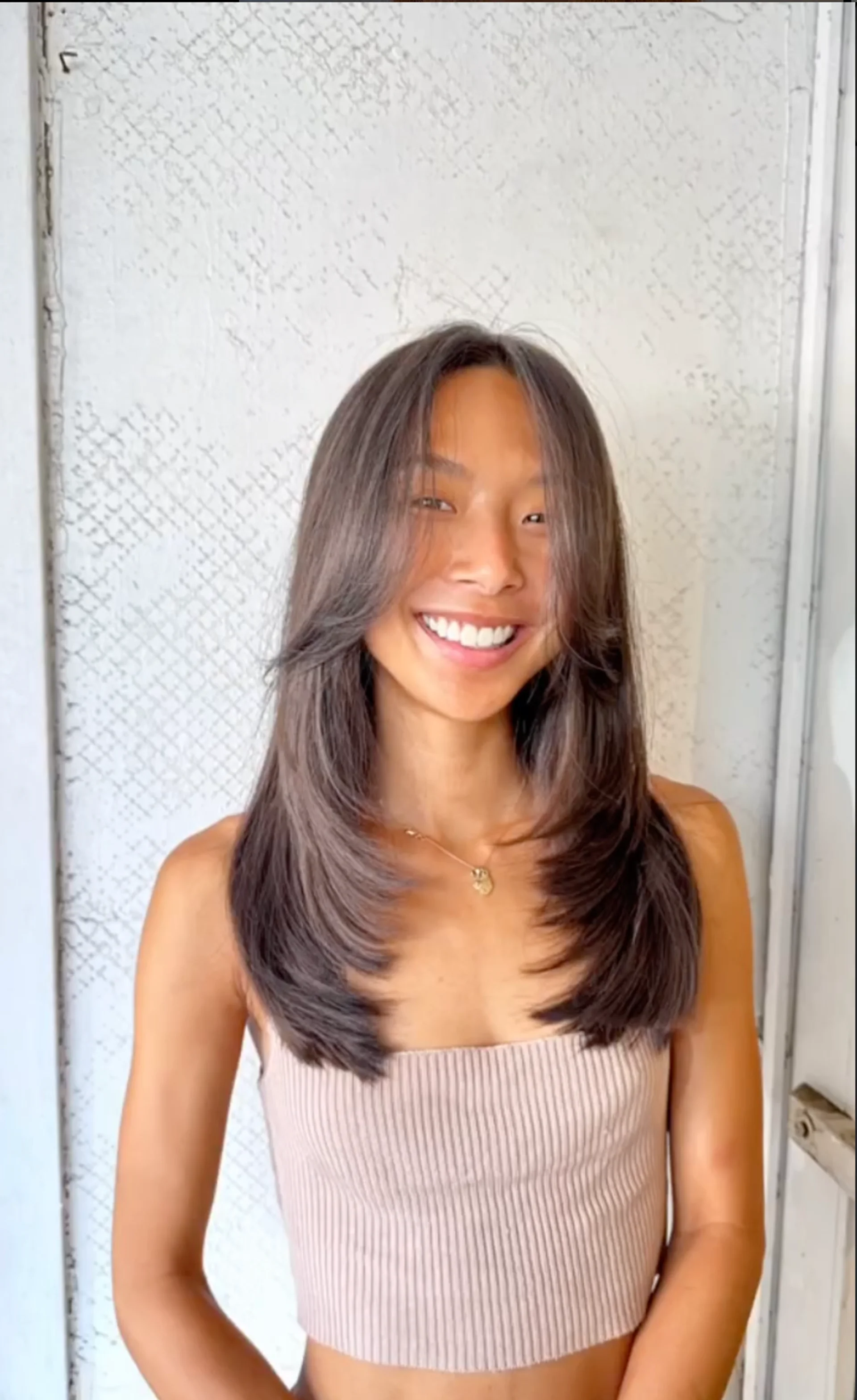 A woman with extremely long, straight, dark hair showcasing the 'glass hair' trend, a key look for NYC in 2026. - Preview 2