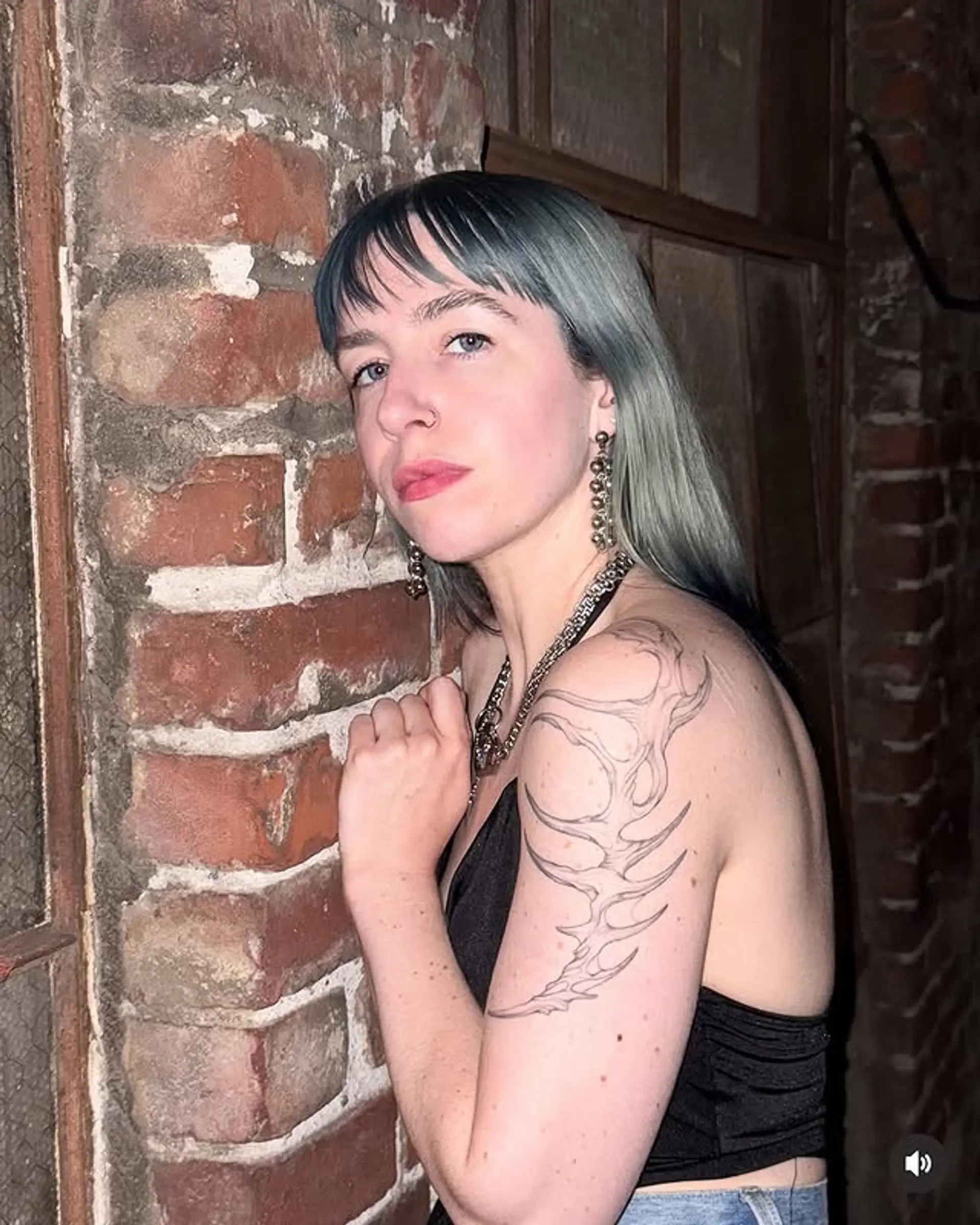 A medium length straight hair style with blunt bangs, dyed a silver or grey hue. 1