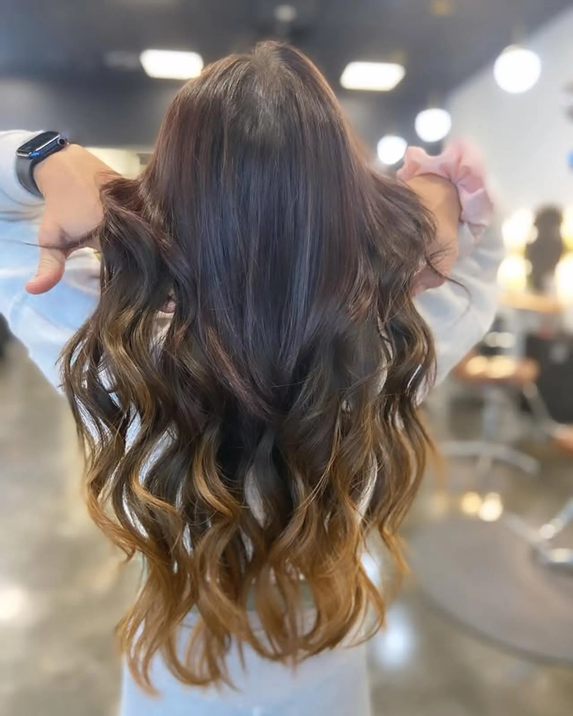 Long, layered, wavy hair with a seamless ombre color melt. 1