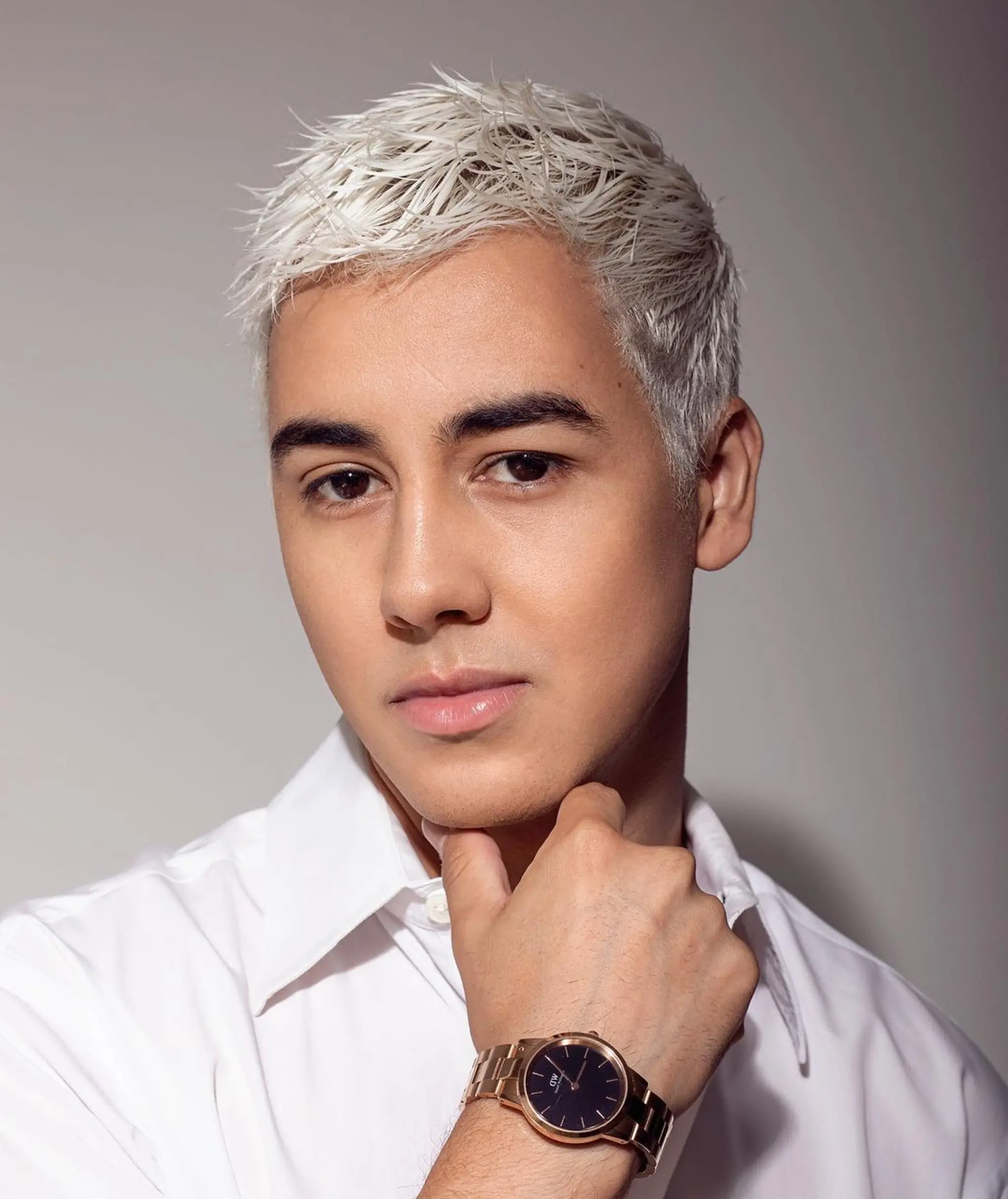 A sleek and stylish short haircut with textured and closely cropped straight hair, featuring a striking platinum blonde color.