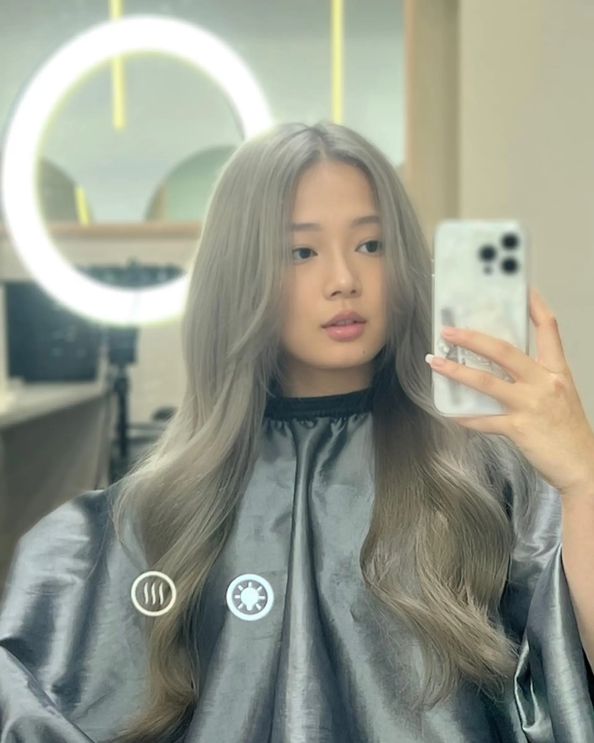 A trendy medium-length haircut with face-framing layers and soft waves. 3