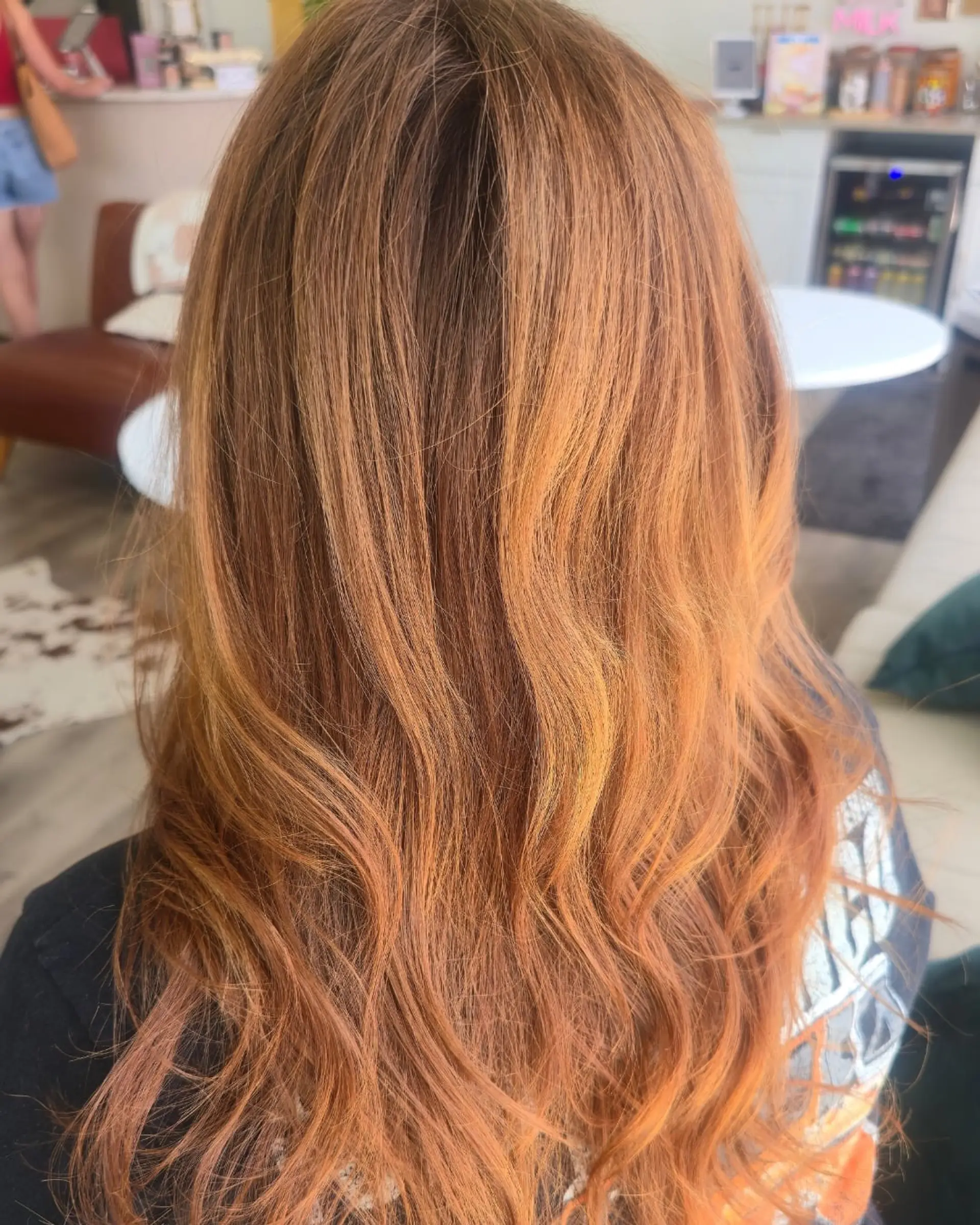 Long dimensional copper hair styled with effortless, soft waves. 1