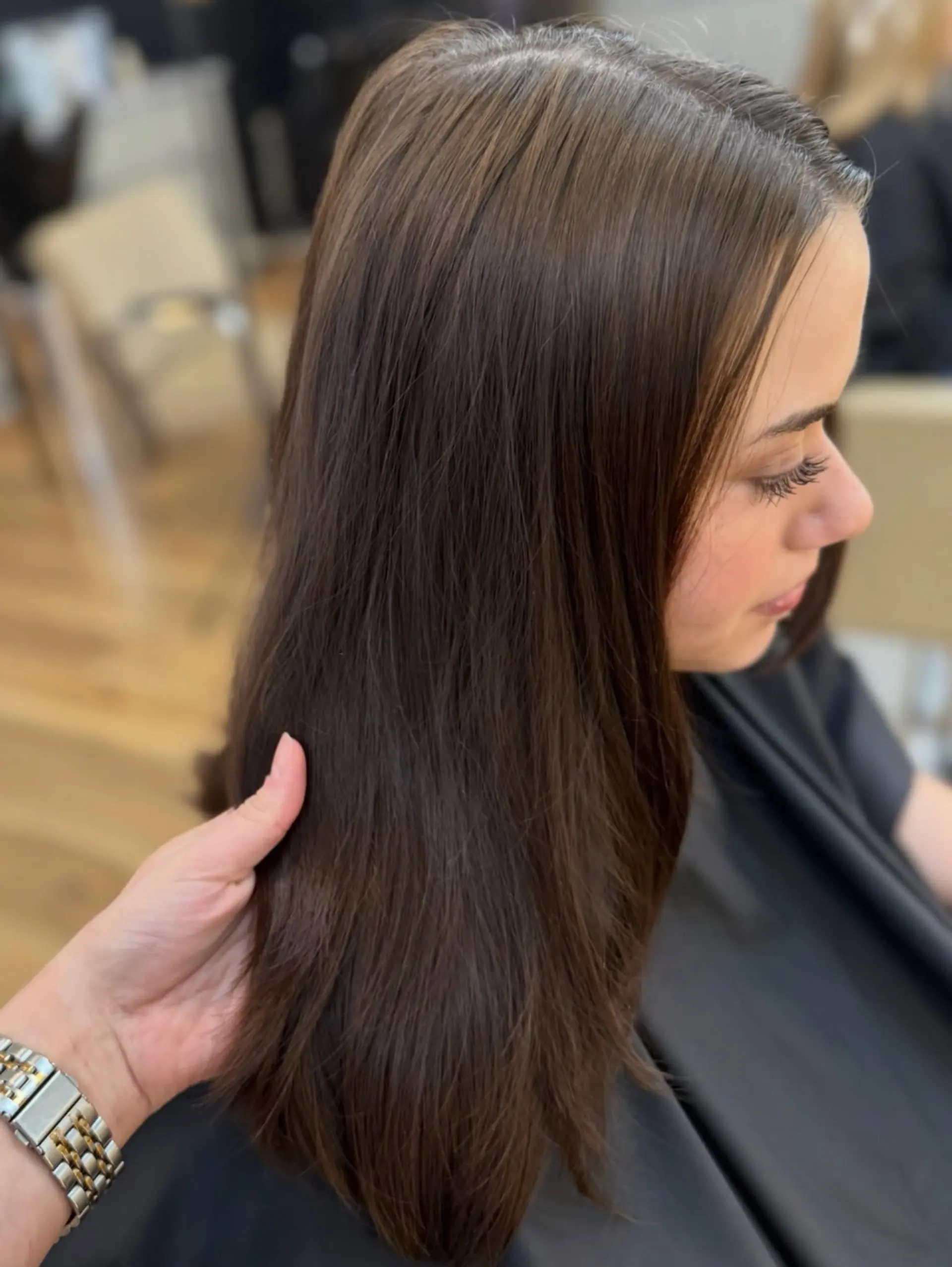 Glossy, rich chocolate brunette hair styled into a smooth, straight blowout with natural body. 1