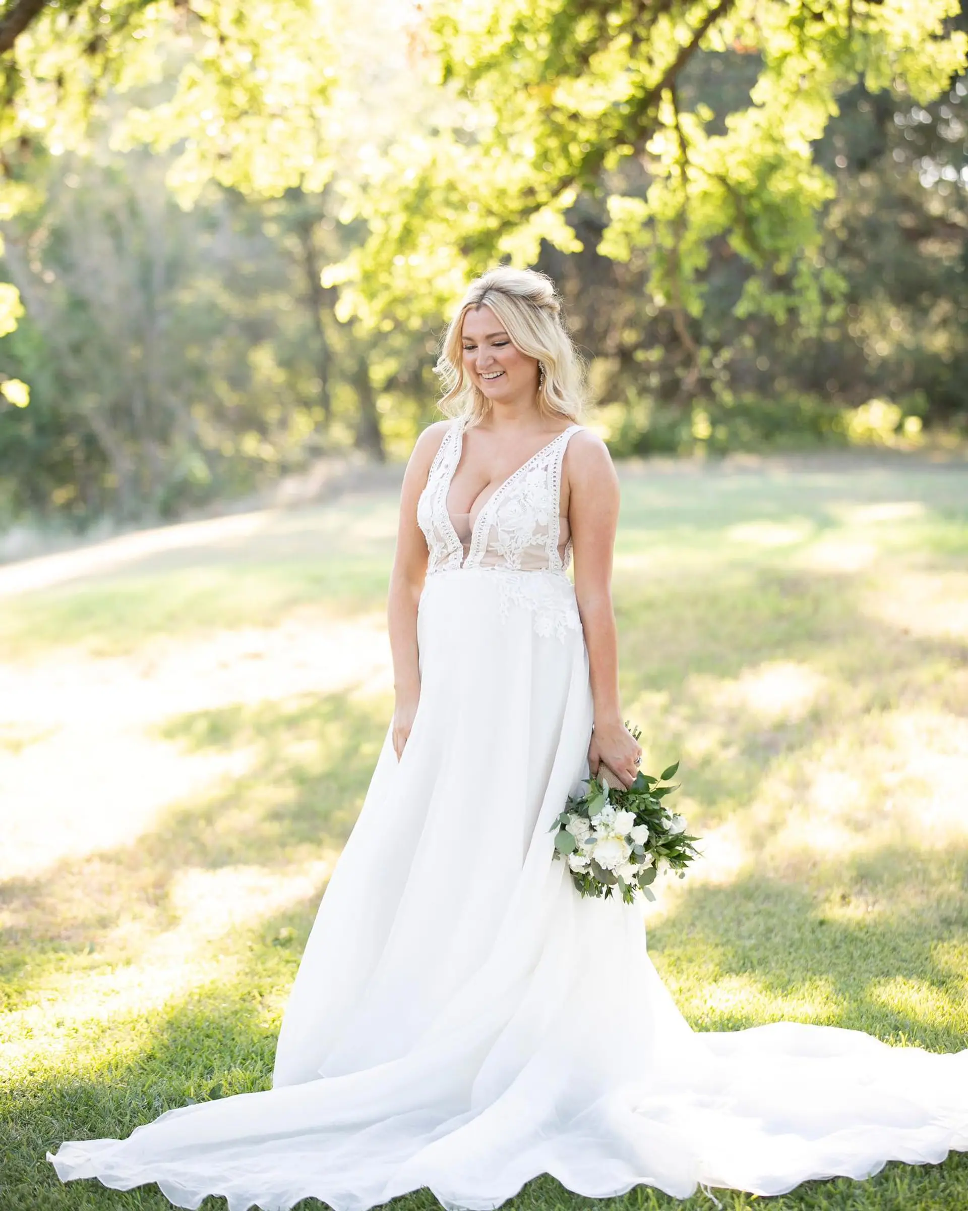 Soft wavy bridal half-up style with center-parted face-framing sections. 1