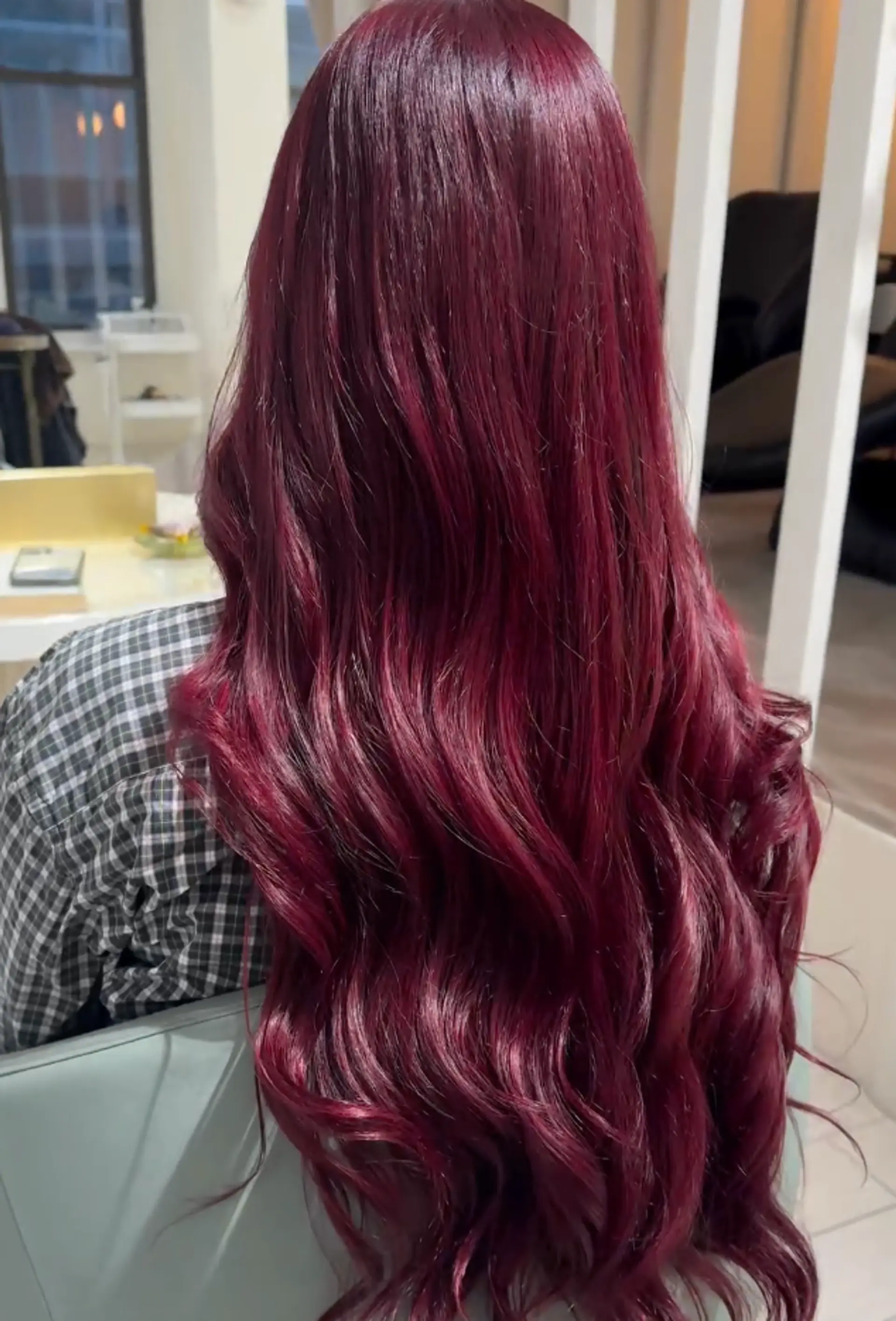 Very long, wavy hair styled in flowing, luxurious waves with a rich, deep burgundy color and a glossy finish.
 1