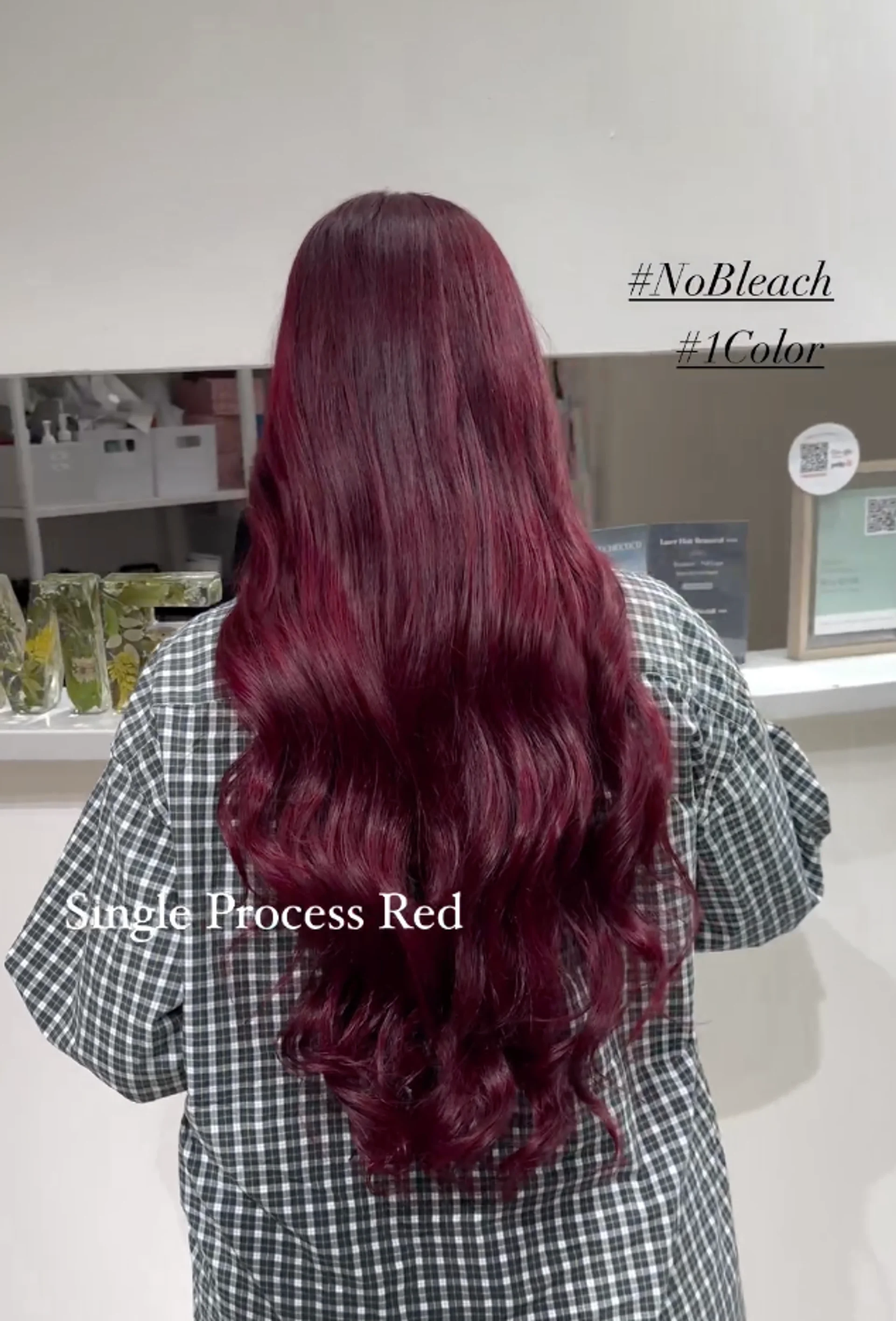 A woman with long, glossy cherry red waves, showcasing the luxurious 'Cherry Lacquer' hair trend of 2026. - Preview 1