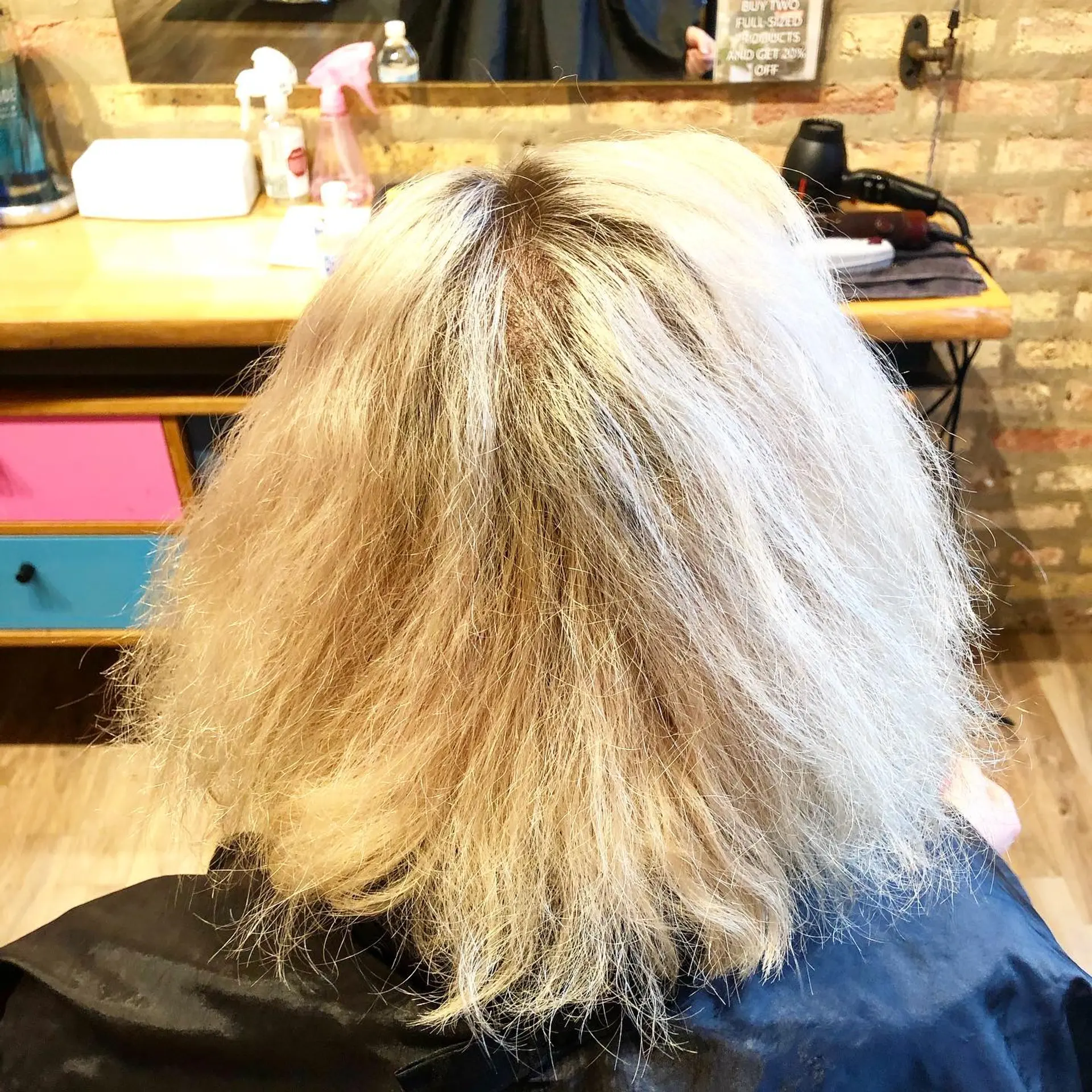 A platinum blonde to brown and teal highlight wavy bob 2