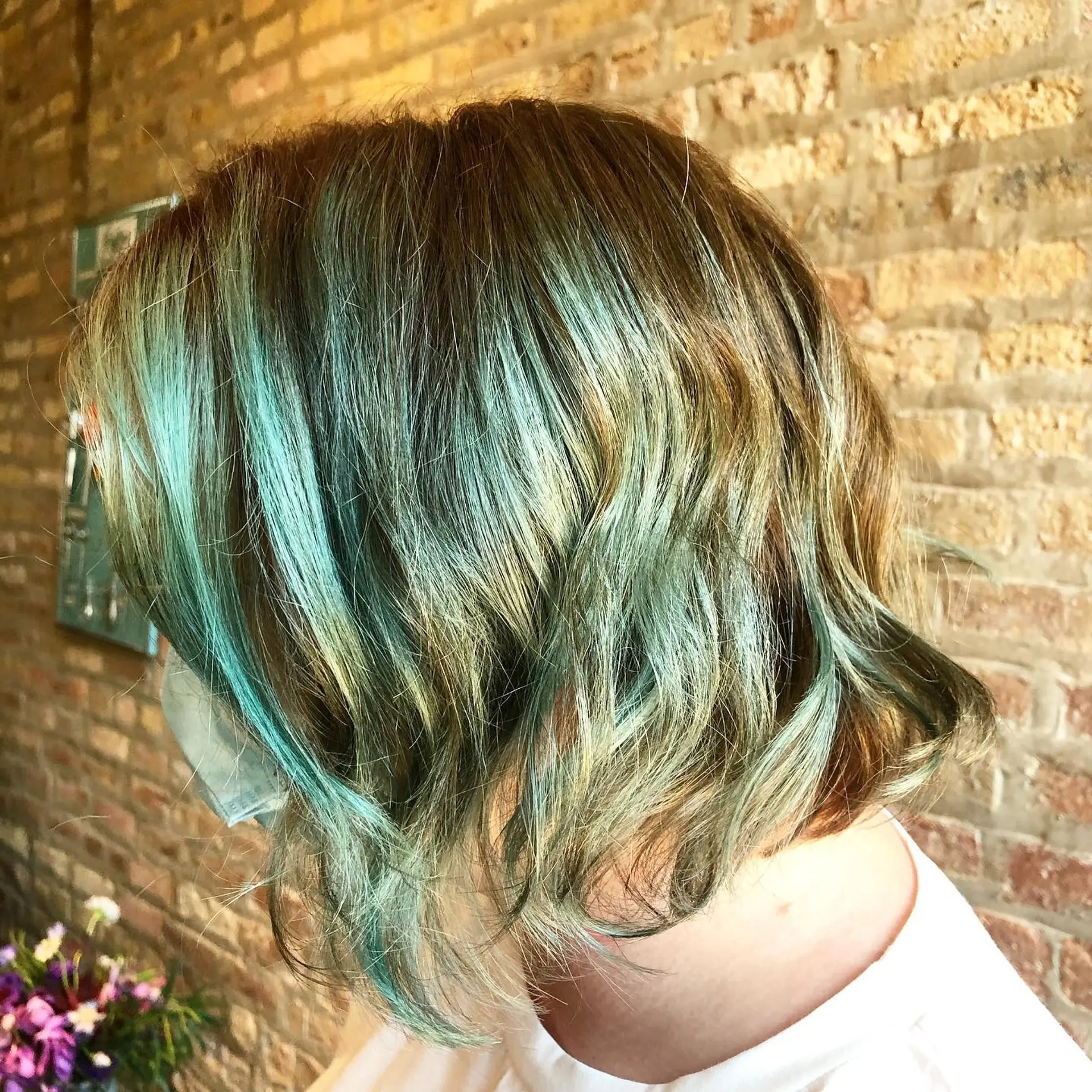 A platinum blonde to brown and teal highlight wavy bob 1