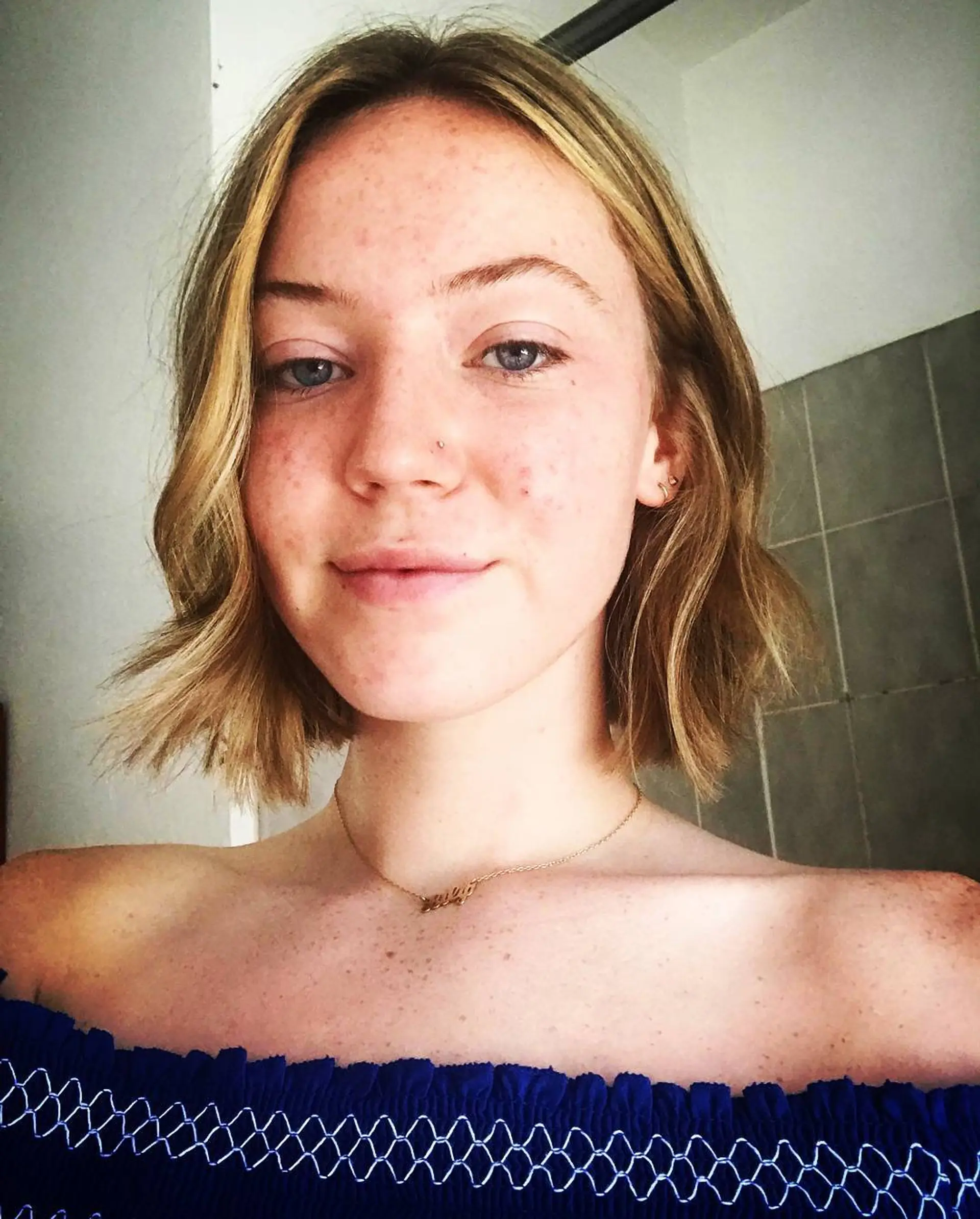 A chin-length textured bob styled with effortless, undone waves and a soft center part. 1