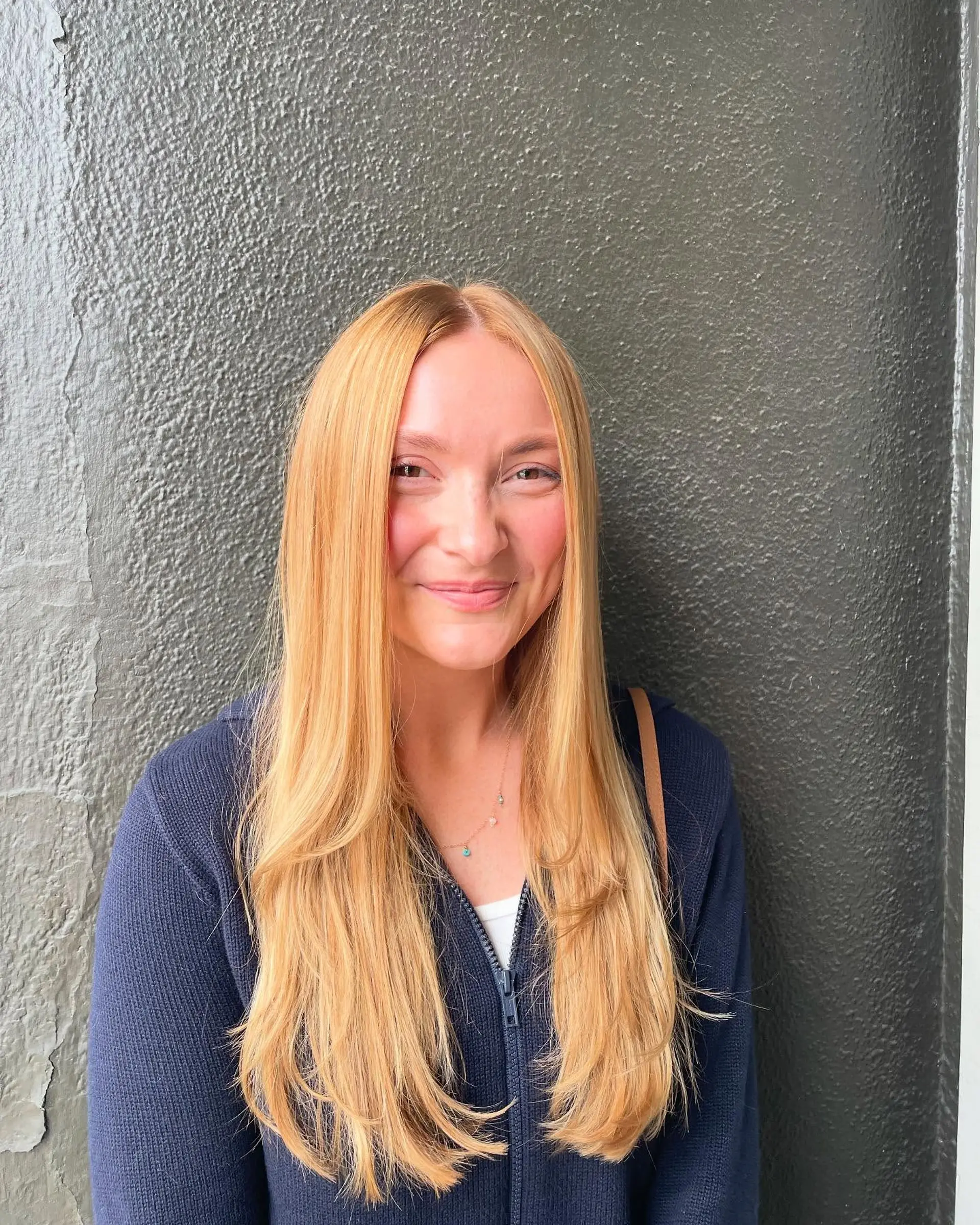 Long, layered hairstyle with face-framing layers. 1