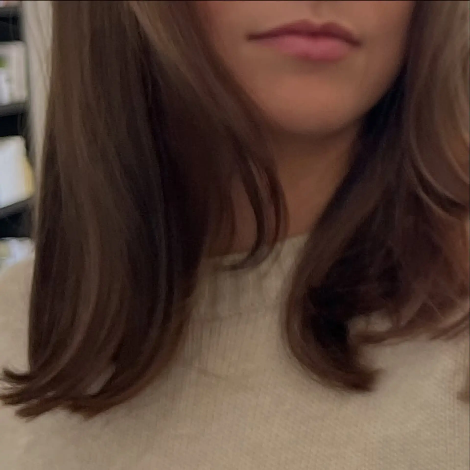 Medium-length brunette hair styled with soft, face-framing layers and smooth, flipped ends. 1