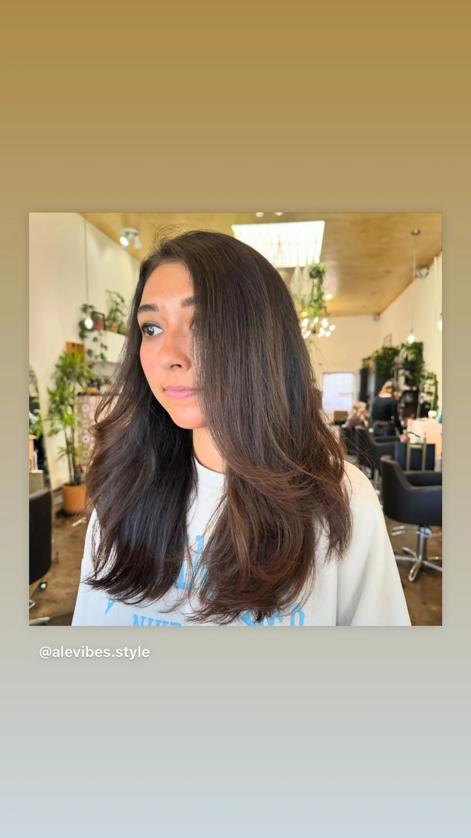 A medium-length layered haircut with face-framing layers and a salon blowout. 1