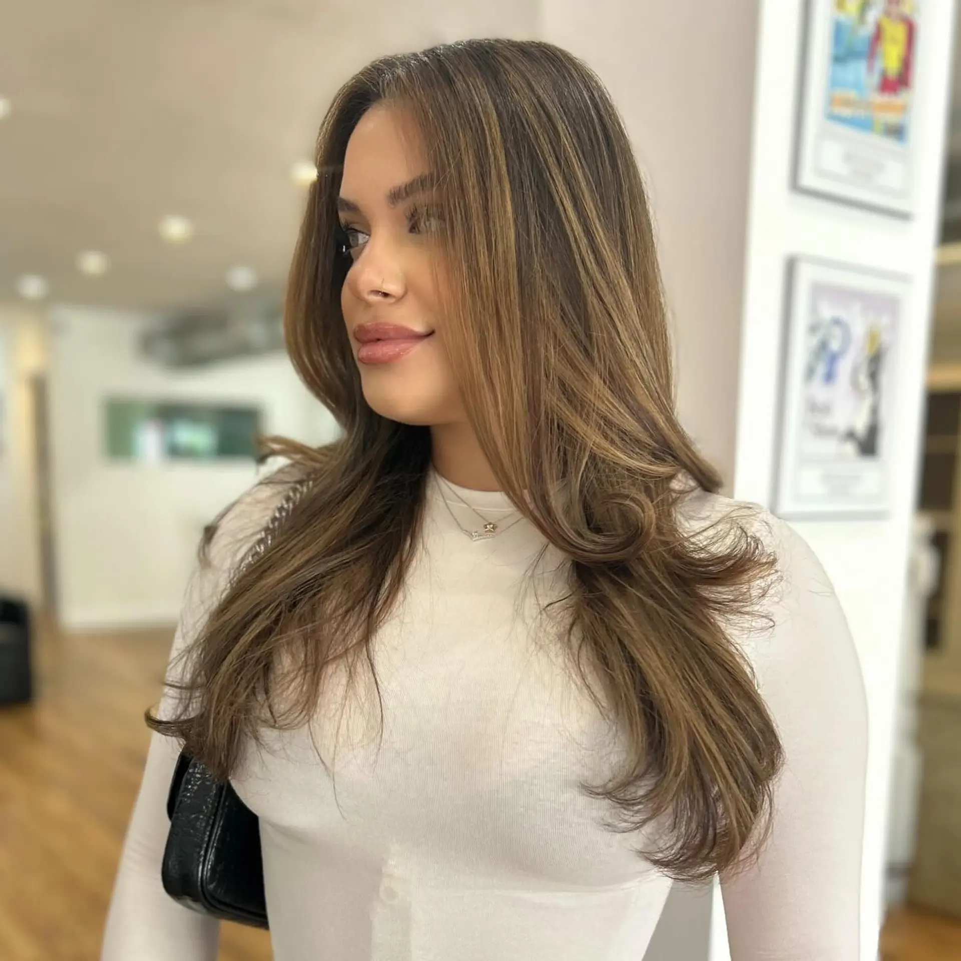A long, layered hairstyle with a bronde balayage. 1
