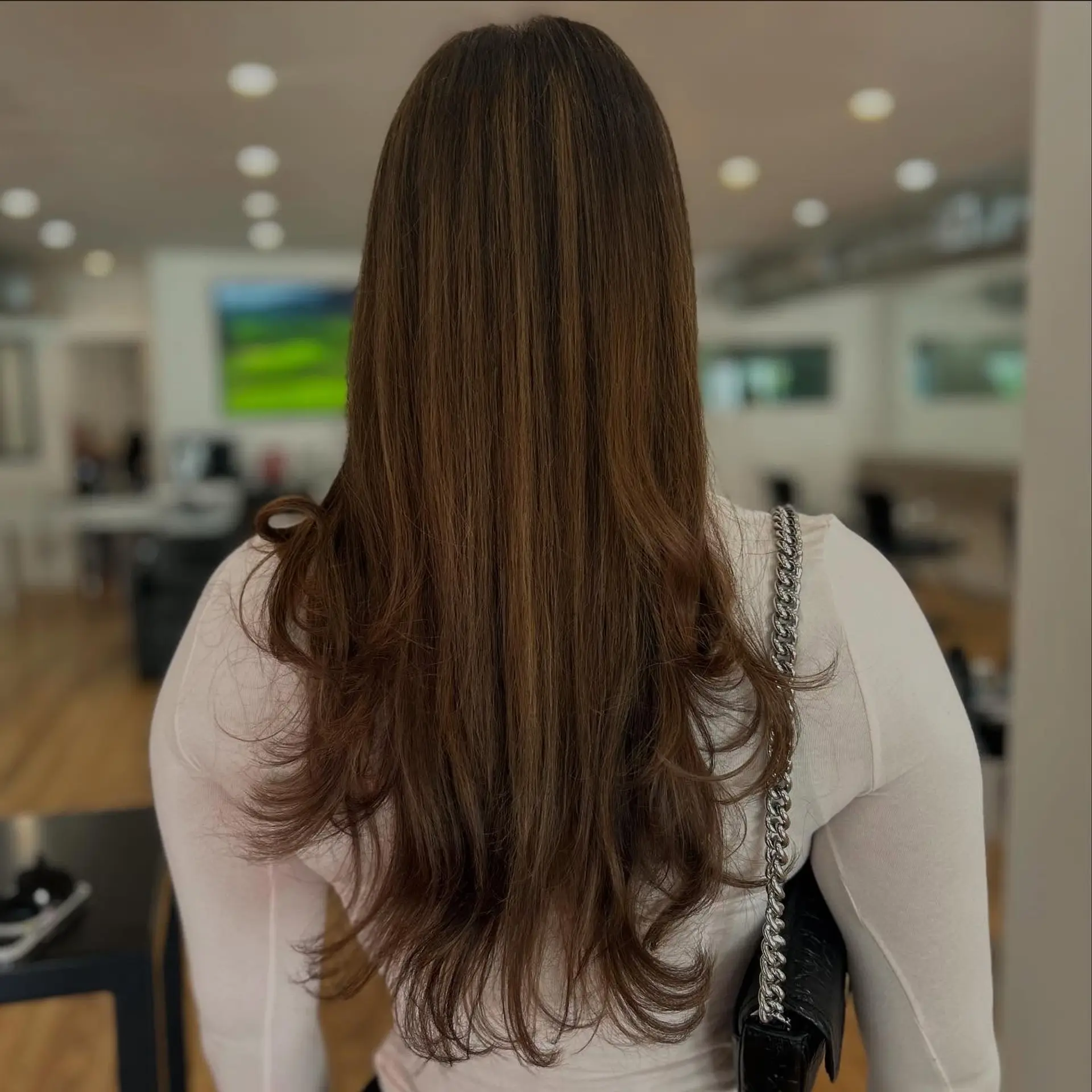 A long, layered hairstyle with a bronde balayage. 4