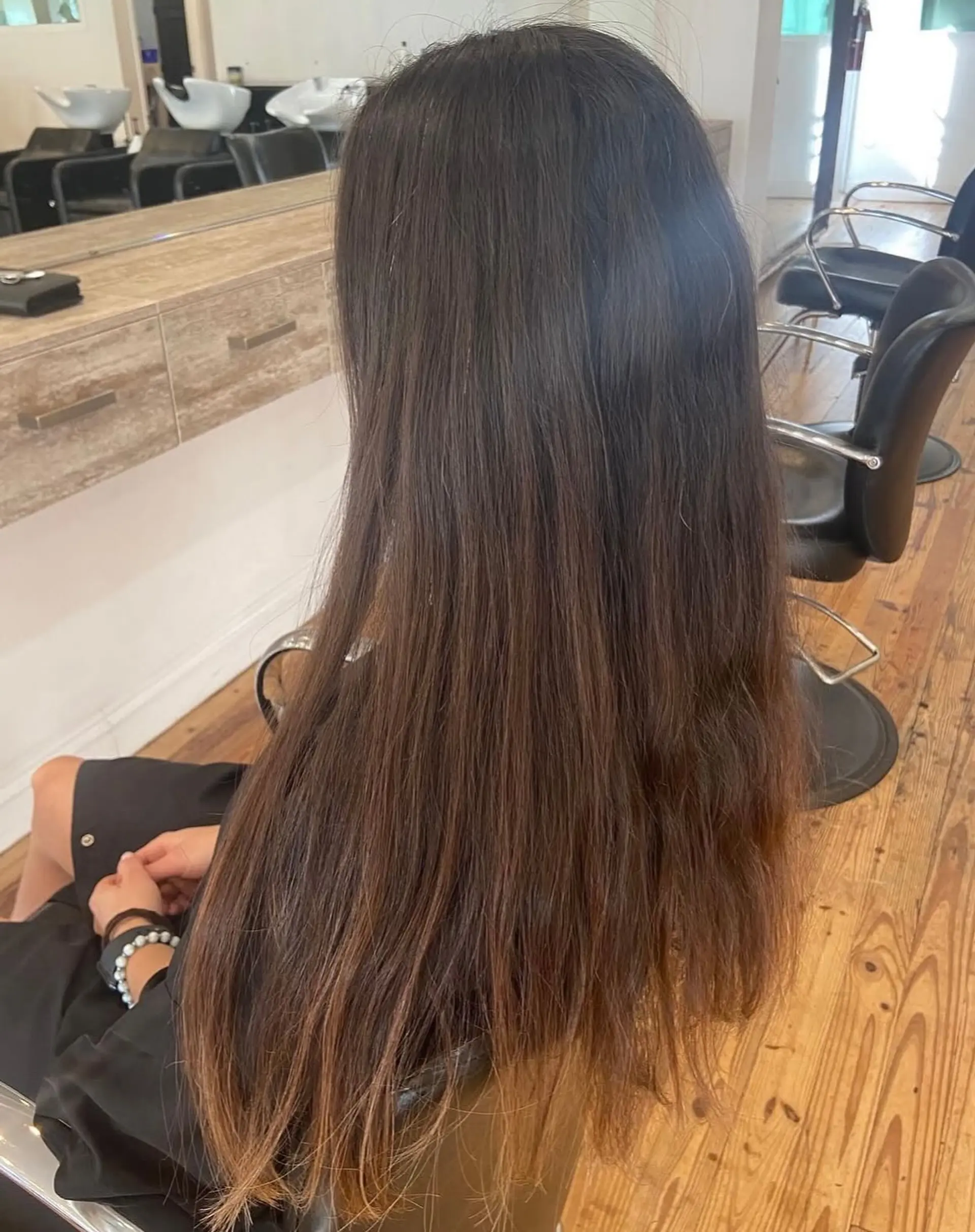 A long, wavy hairstyle with a dimensional balayage color technique. 2