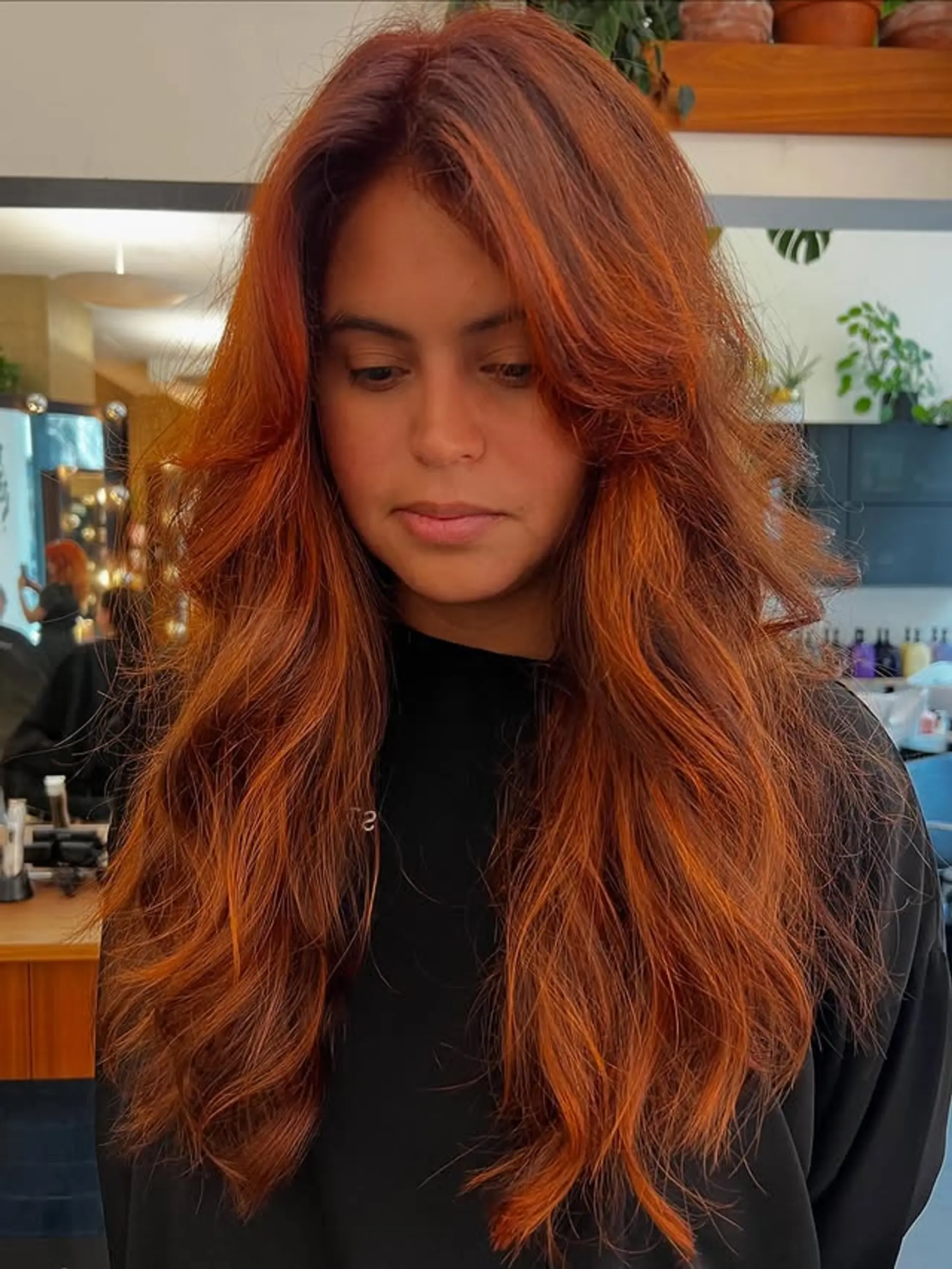 A long, layered hairstyle with face-framing layers and a wavy texture. 1