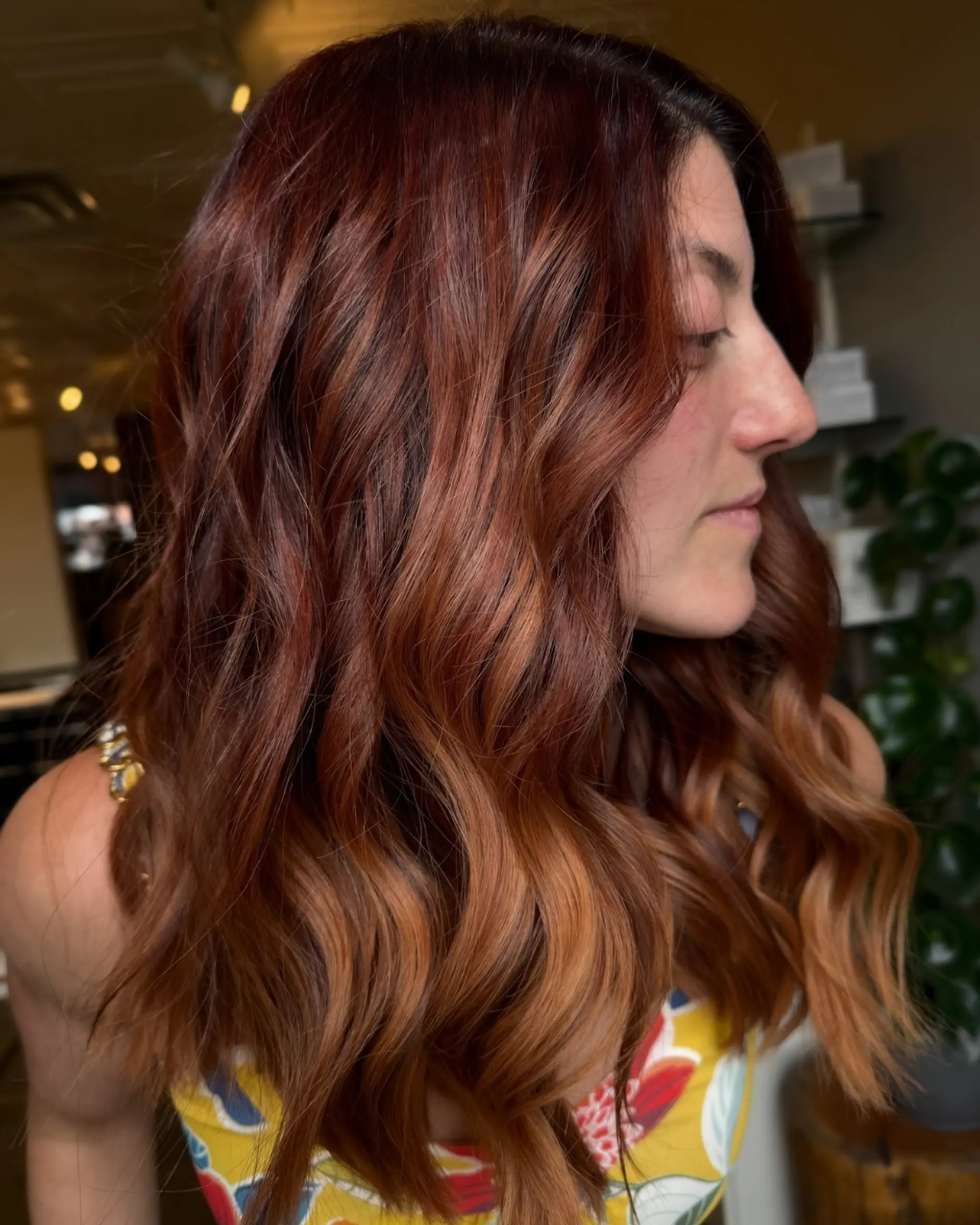 Rich auburn hair styled in soft, dimensional waves with copper tones. 1