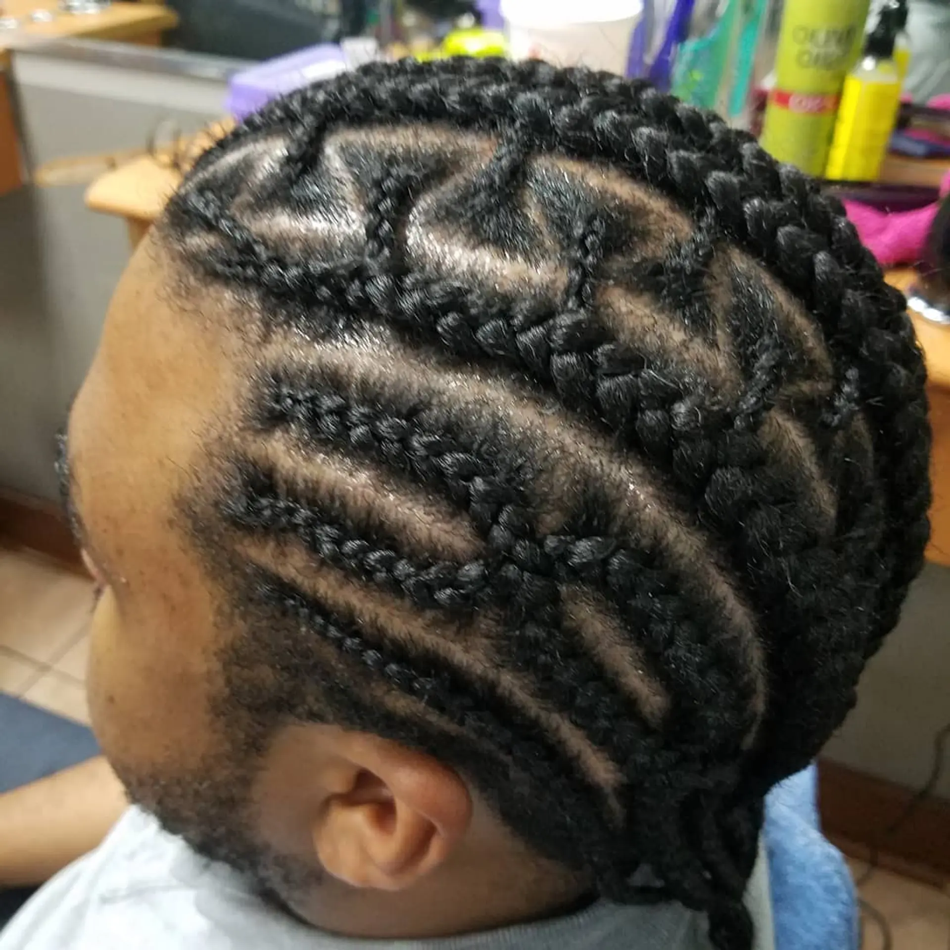 Short hair styled into intricate cornrows with a zig-zag pattern. 1