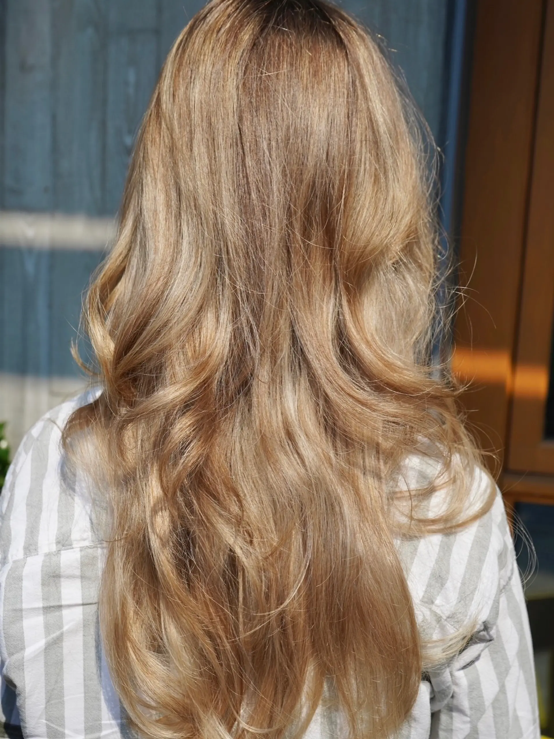 Long, layered warm blonde hair styled with soft, loose waves. 1
