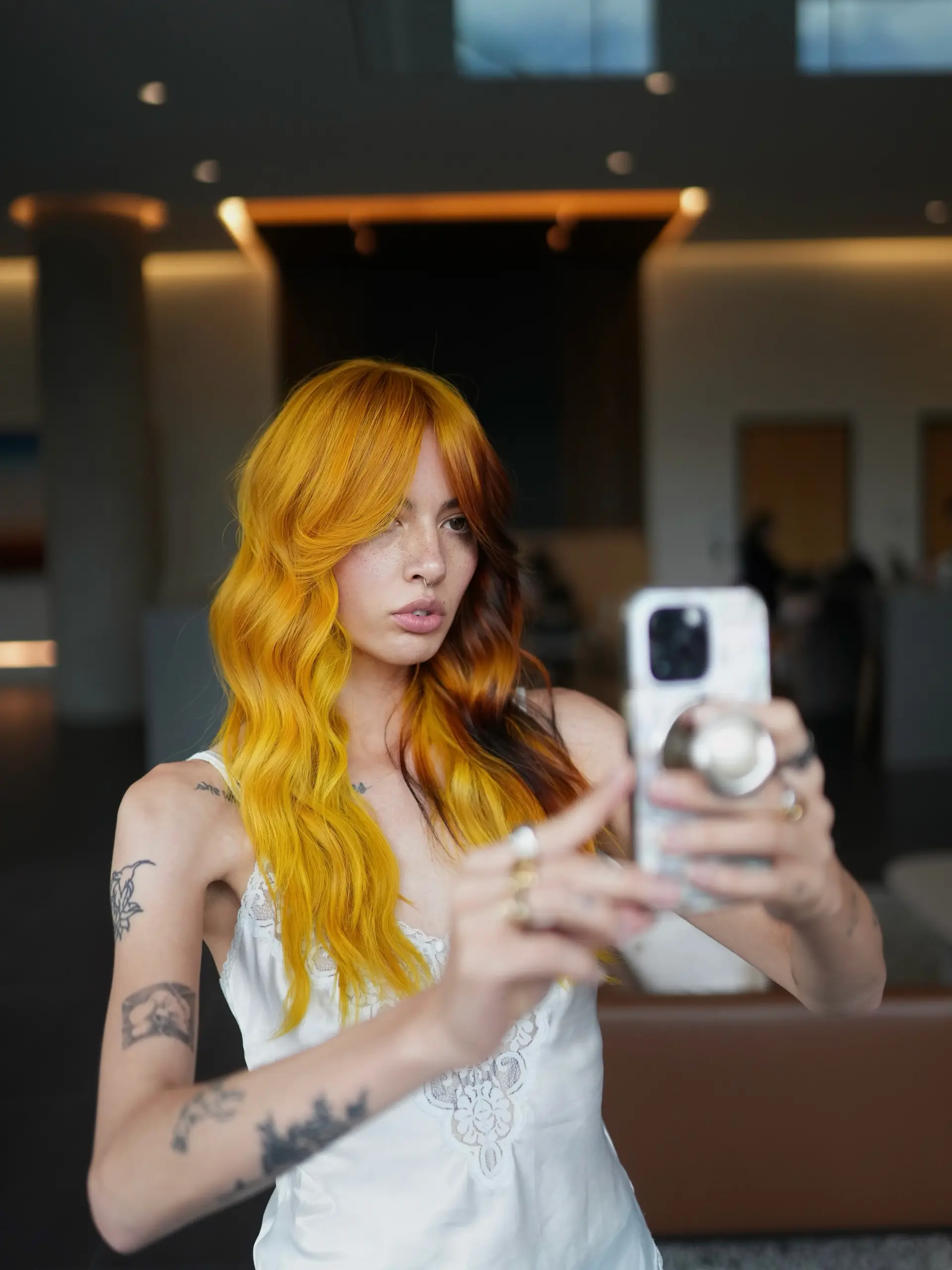 Vibrant split-color long hair featuring bright marigold yellow on one side and warm auburn-copper tones on the other, styled in soft waves. 1