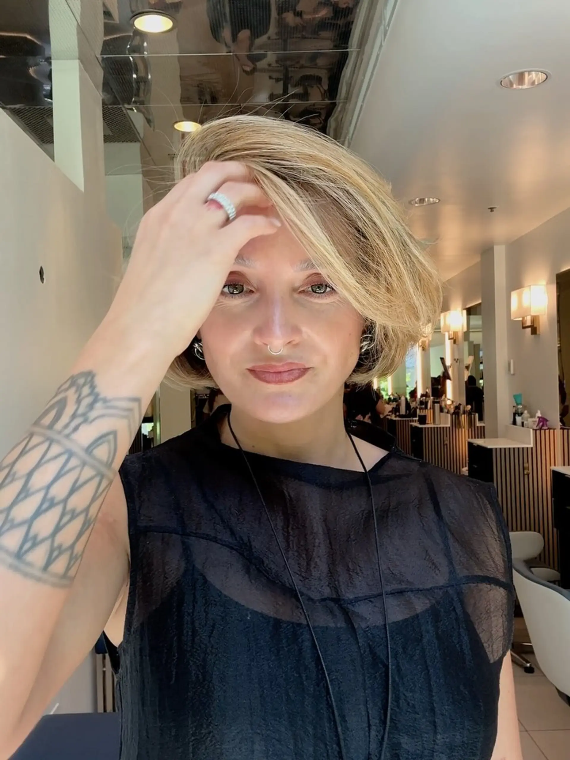 A voluminous chin-length bob with a sweeping side part in a soft creamy blonde shade. 1