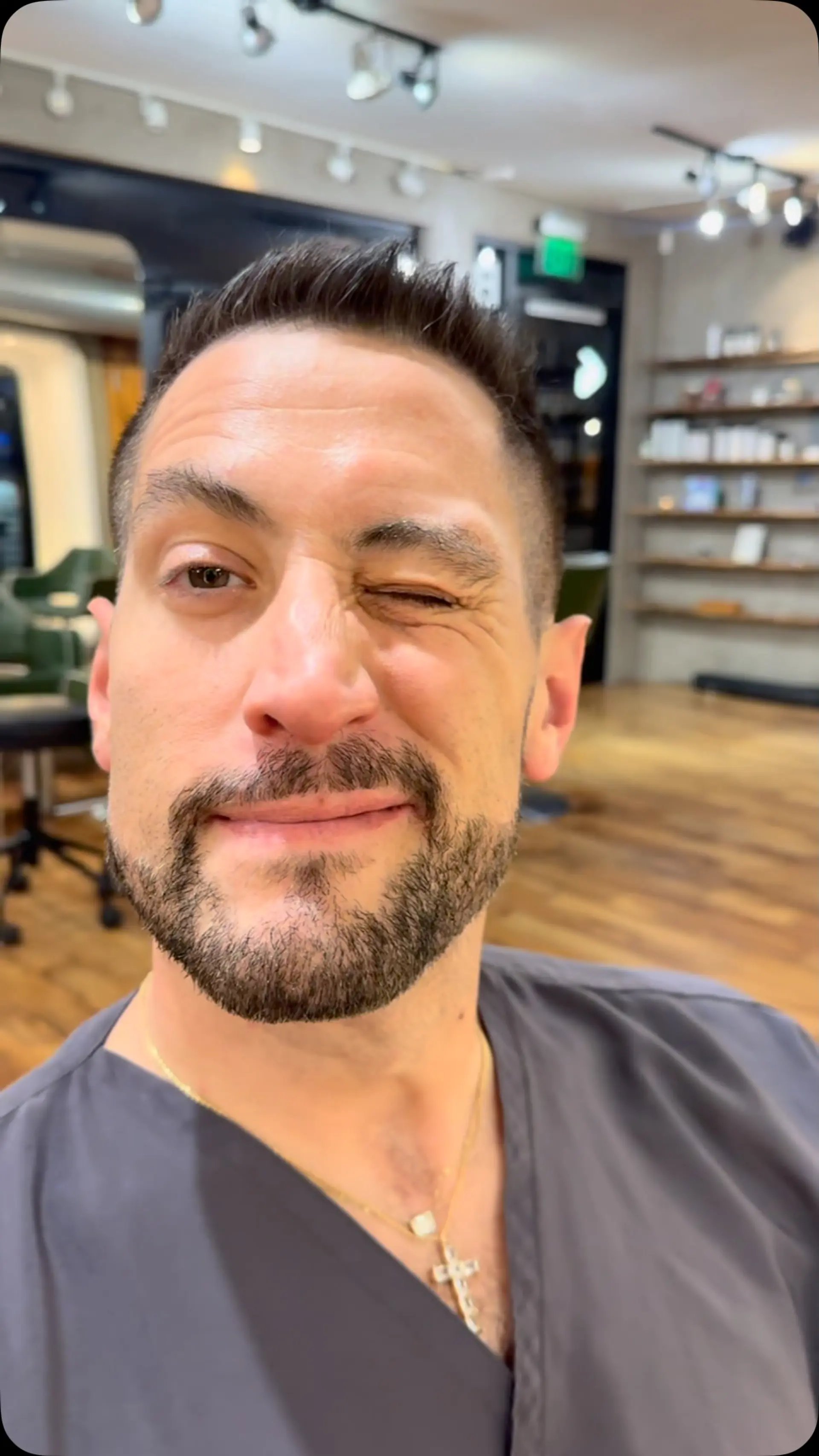 A modern men's short haircut featuring subtle gray blending, textured top styling, and neat tapered sides. 1