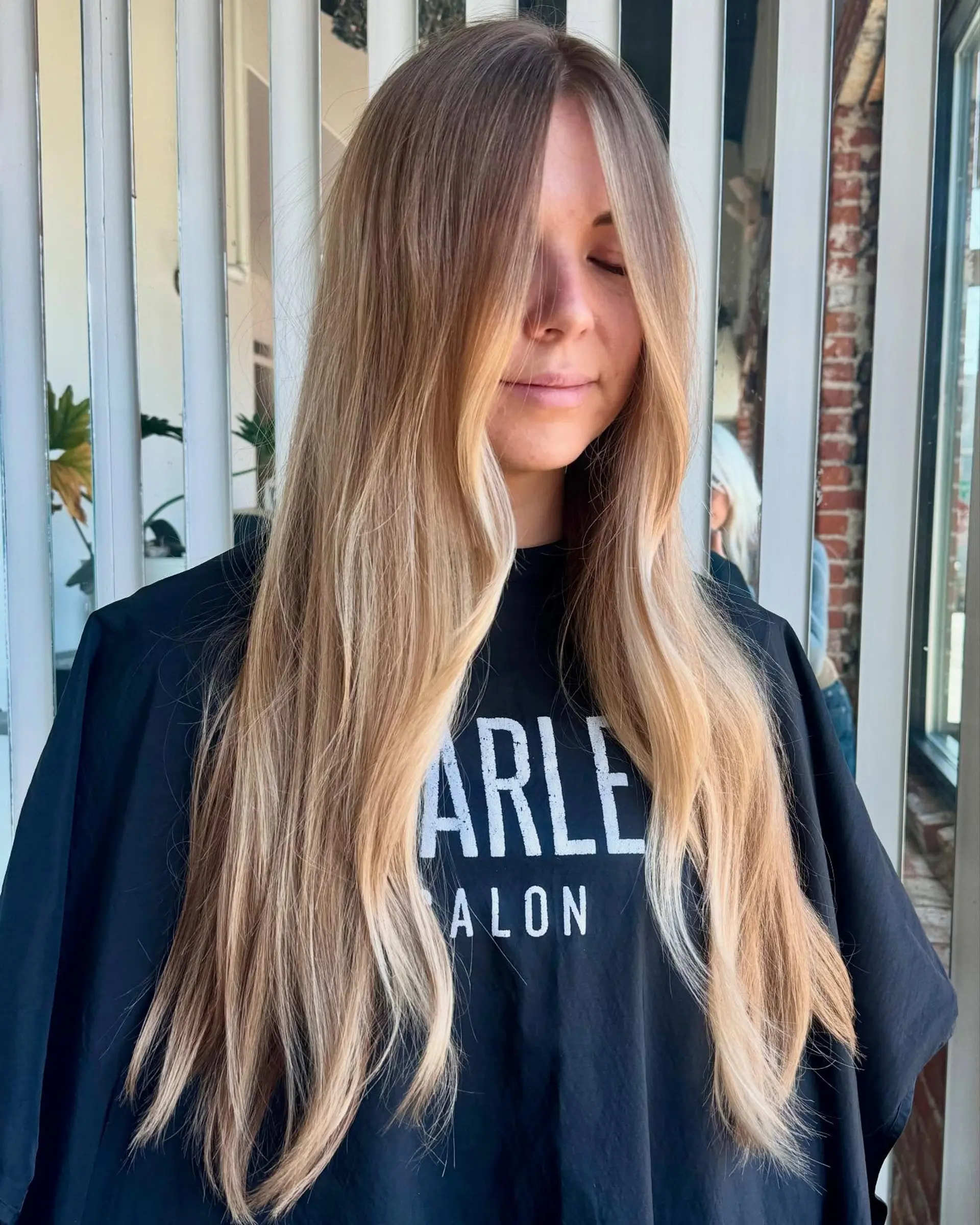 Long lived-in blonde hair featuring bright face-framing highlights and dimensional warm beige blonde tones throughout. 1