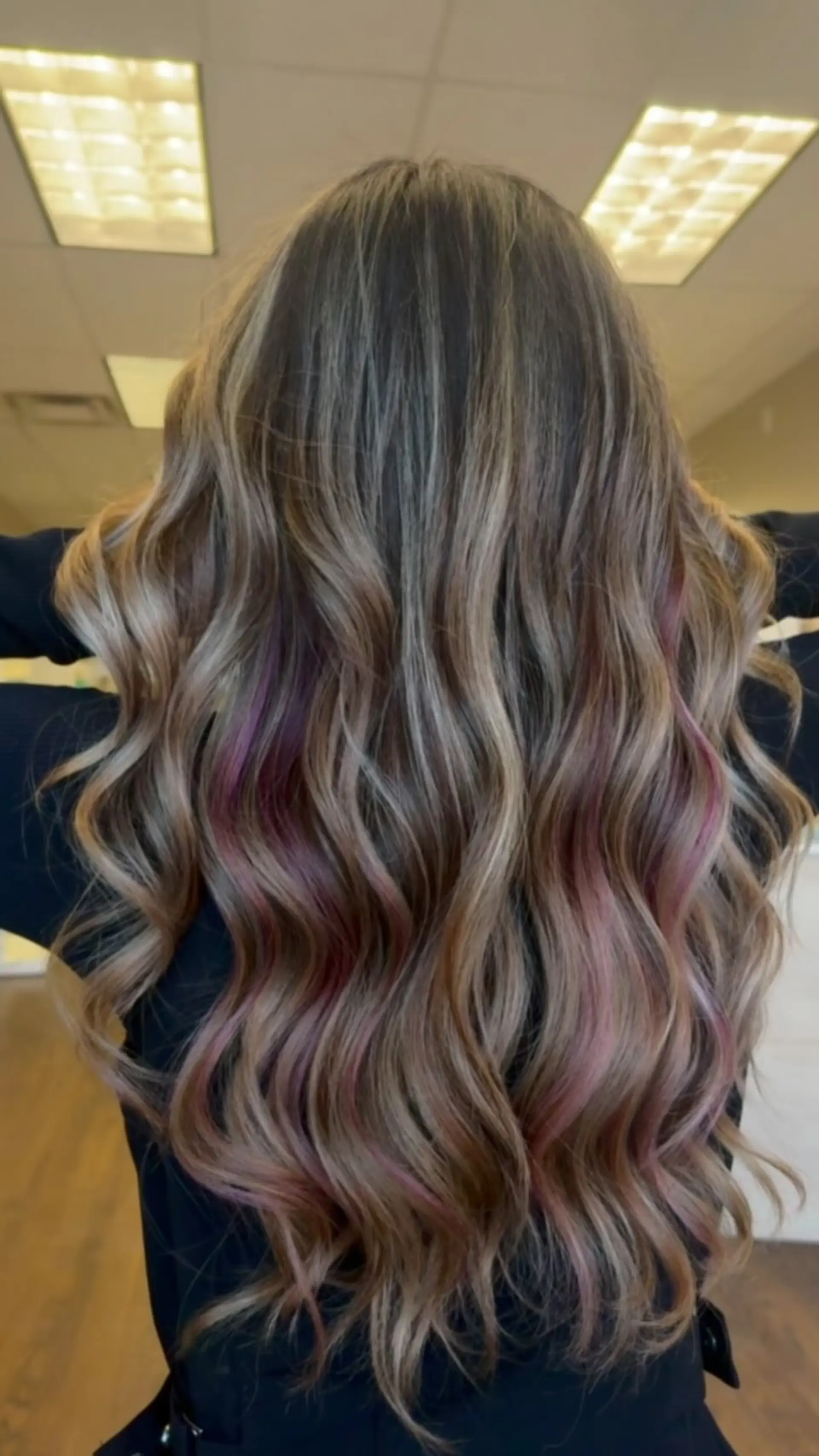 Long ash blonde and brunette balayage styled in loose curls with peekaboo purple highlights. 1