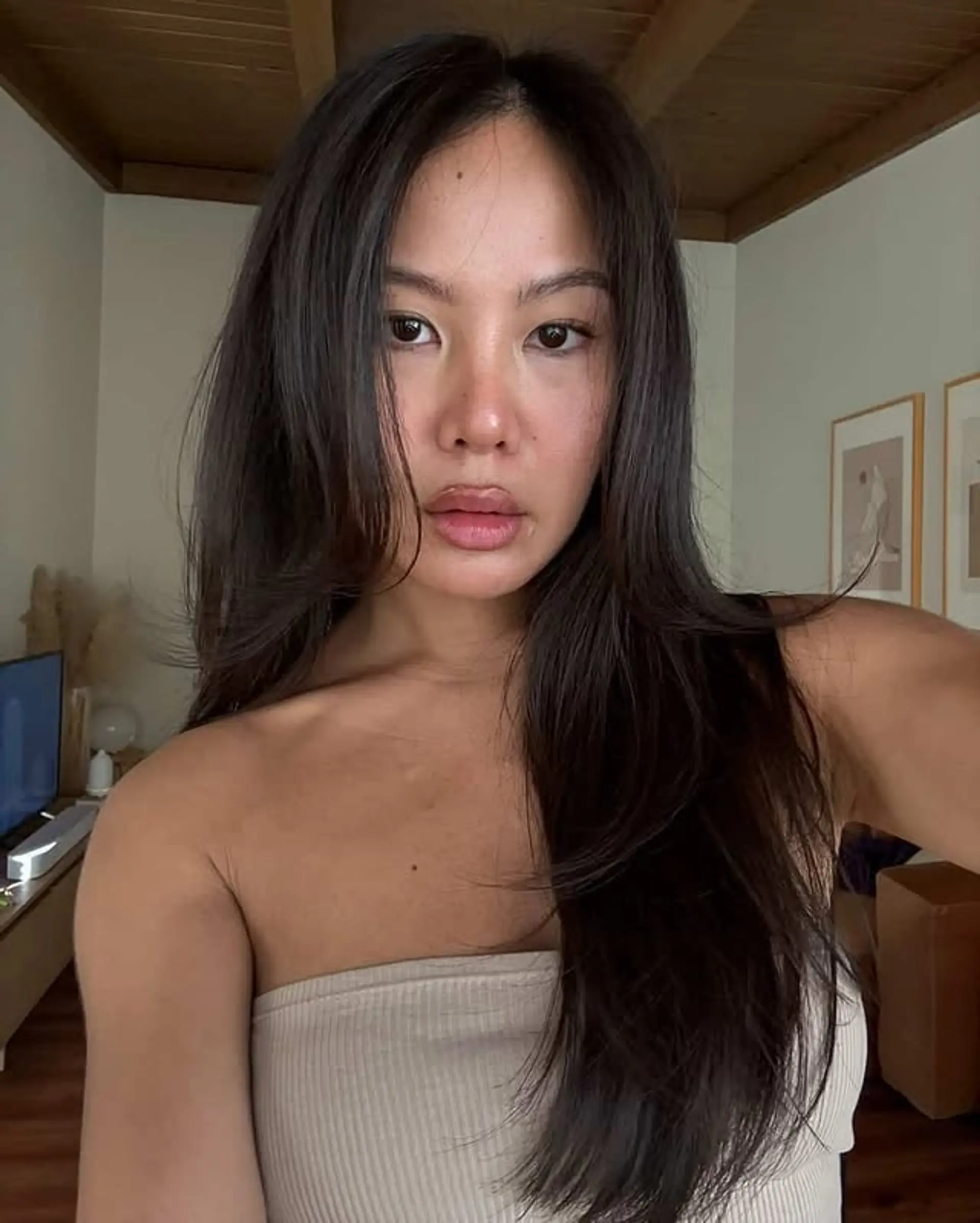 A layered medium-length hairstyle with face-framing layers. 1