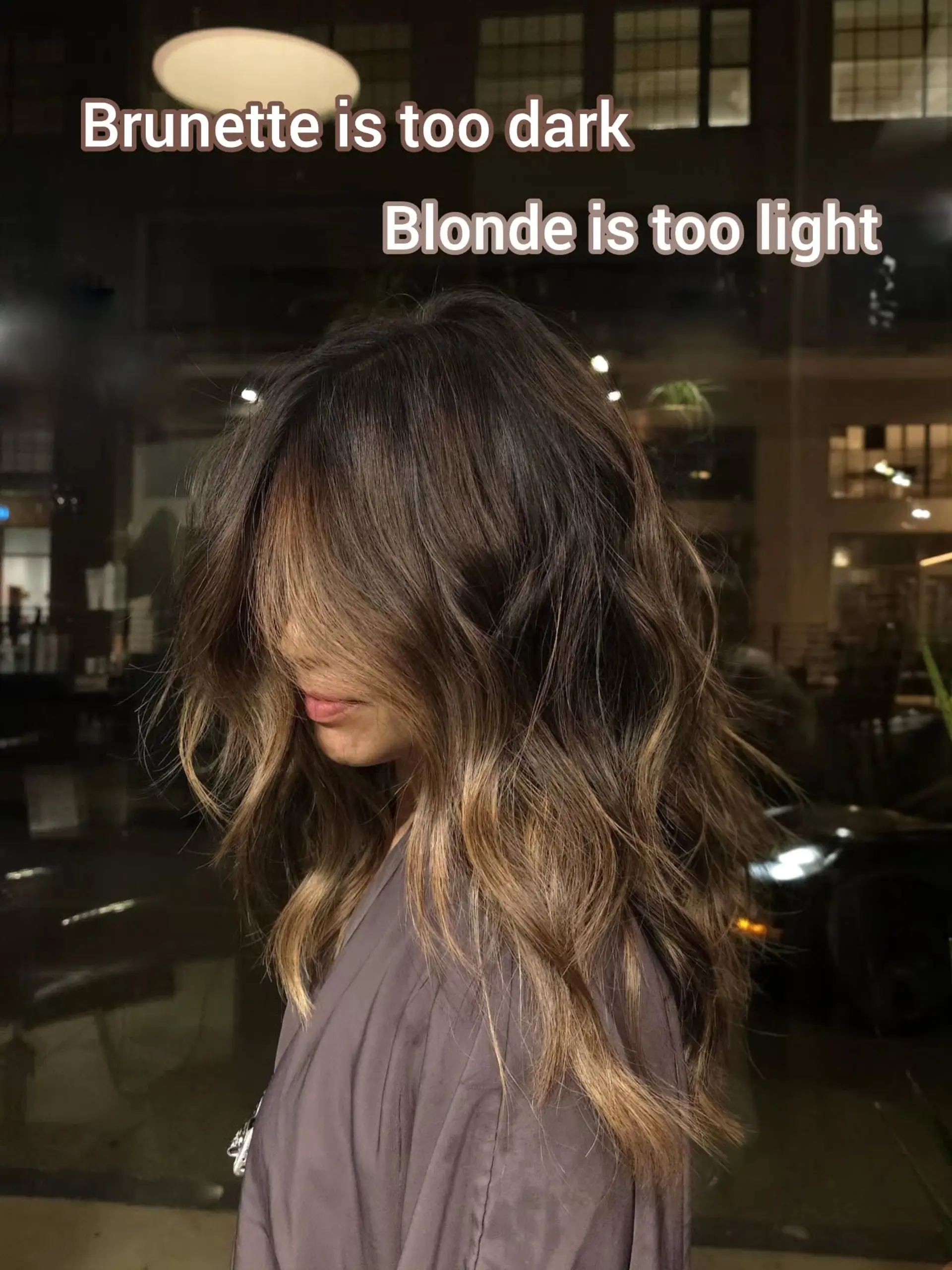 Medium-to-long layered bronde balayage styled into textured, loose waves with sweeping face-framing fringe. 1
