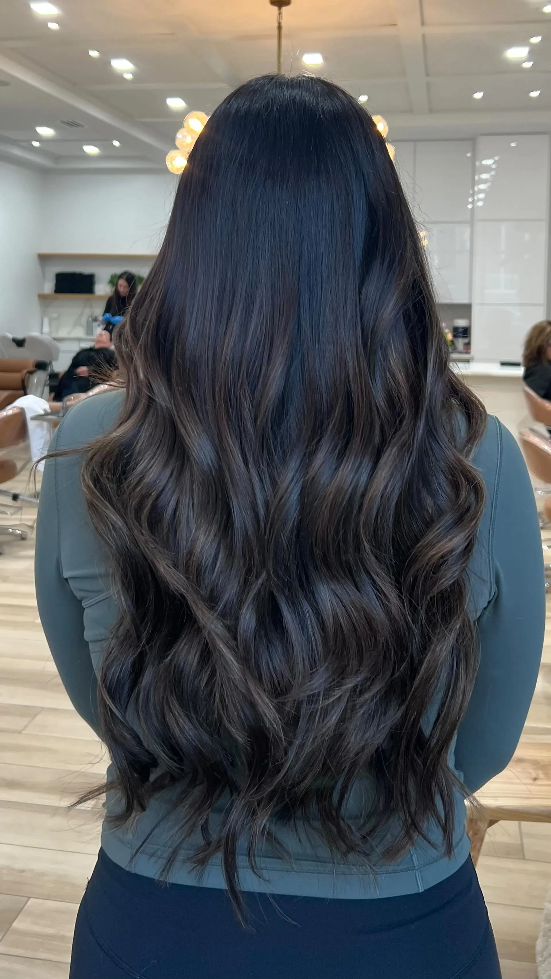 Long, flowing dark mocha brunette hair styled in loose, textured waves with added volume and dimension. 1