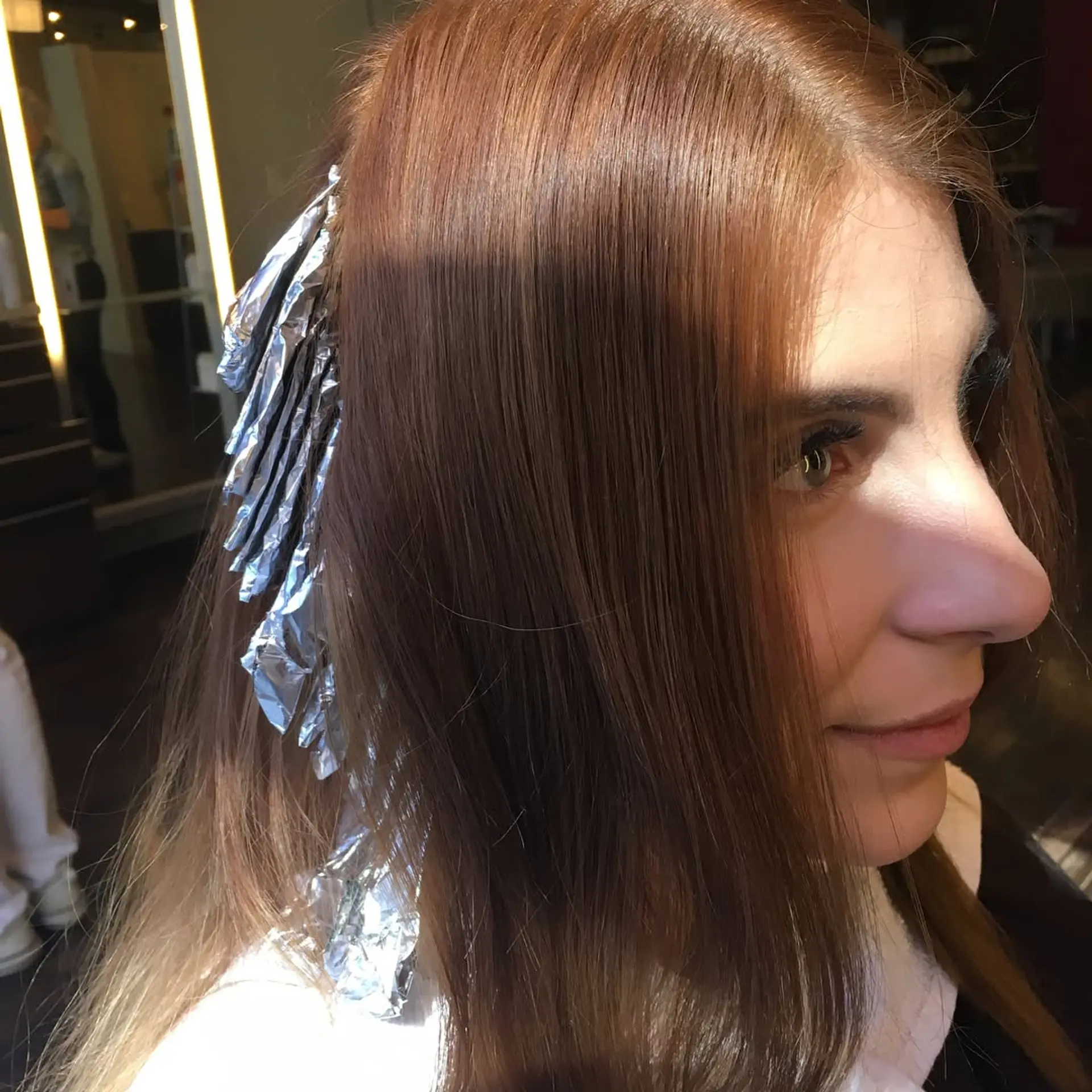 A wavy, medium-length hairstyle featuring a copper base with blonde balayage highlights. 4