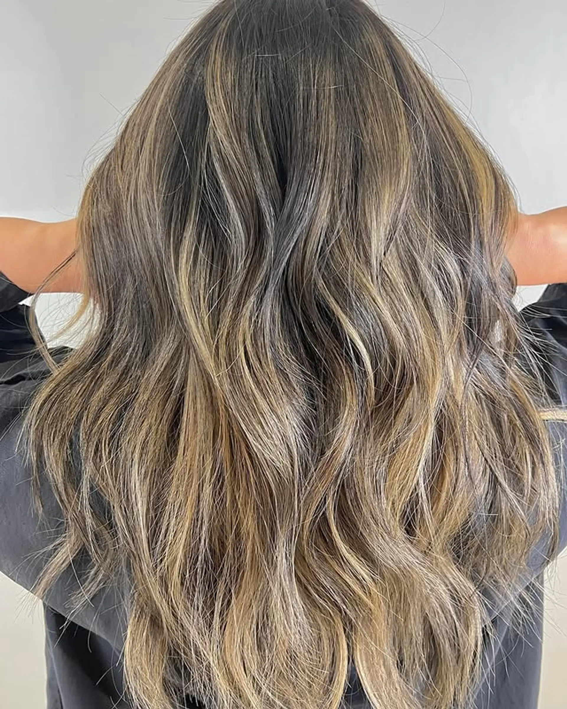 Long wavy hair with a bronde balayage, creating a natural and dimensional look. 1