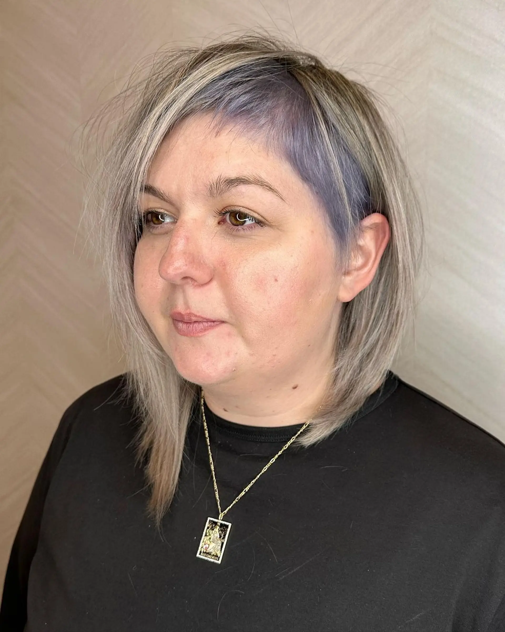 An asymmetrical, medium-length layered hairstyle with silver and lavender hues. Features straight hair with side-swept bangs and contrasting colors for a soft yet edgy finish.

Color by @simabeautynyc
Cut and style by @juliamannino_hair
 1